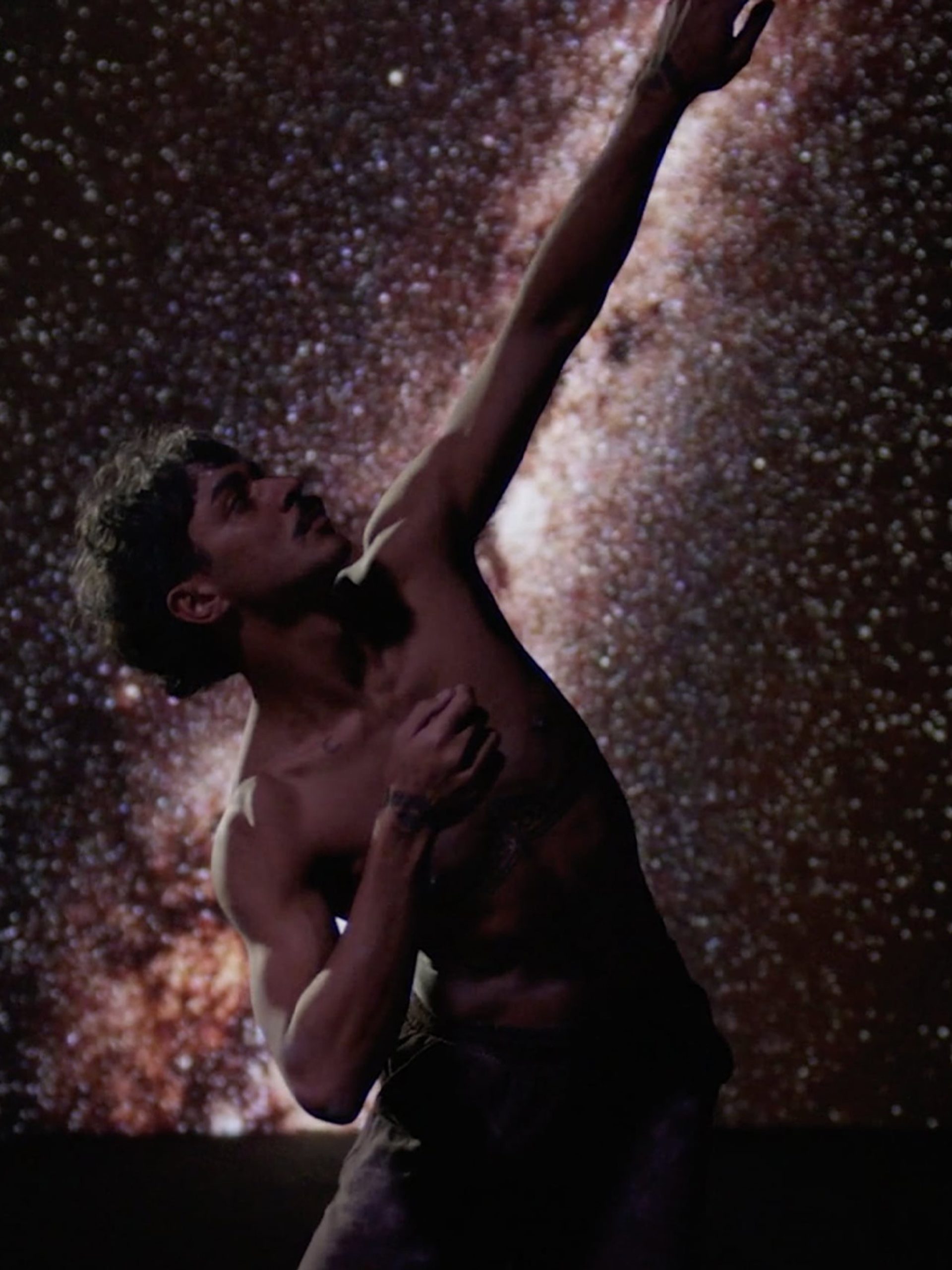Dancing person in front of stars.