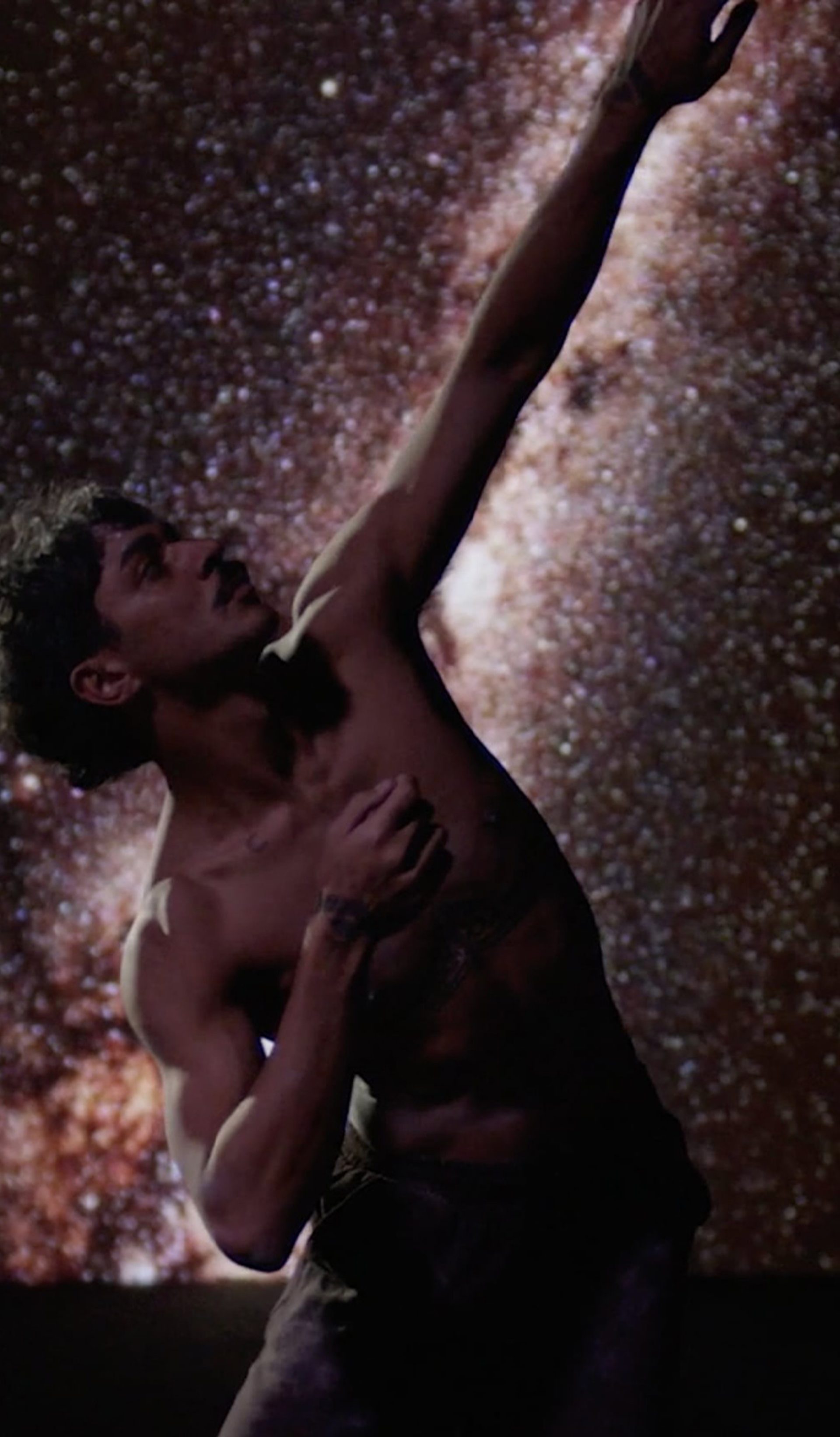 Dancing person in front of stars.