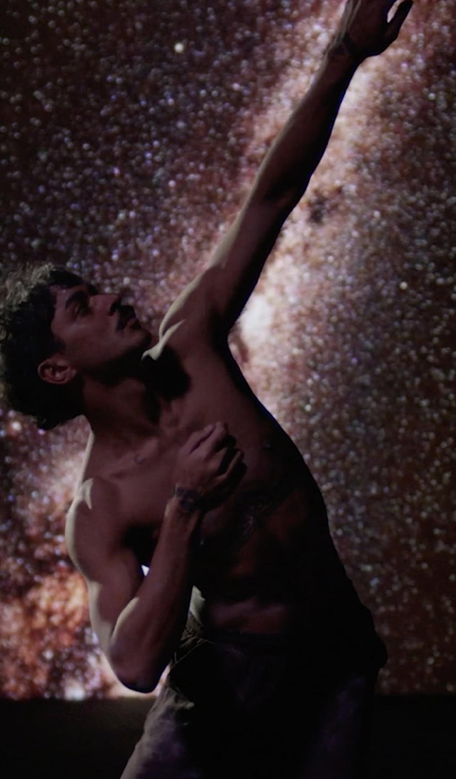 Dancing person in front of stars.