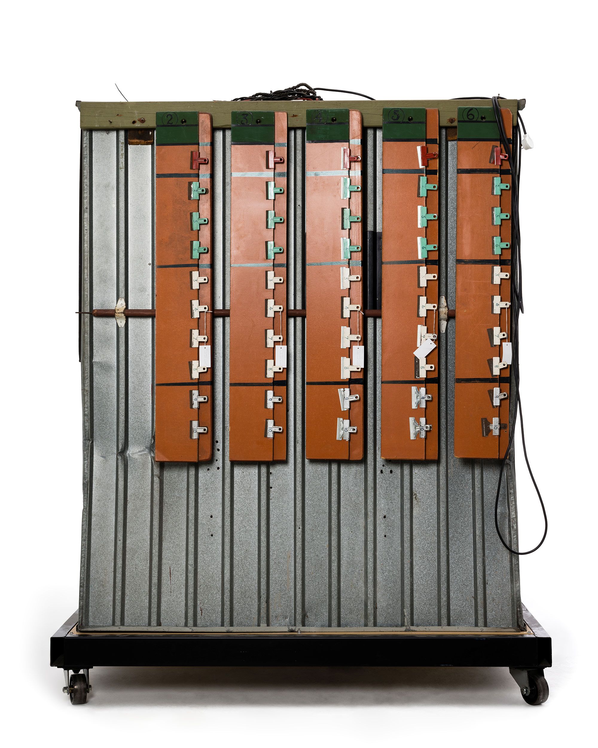 Green and yellow metal 'garden' shed containing elaborate electronic systems built into the interior. Inside the shed is a compartment which contains a seat where the user can sit and be suffused with radio waves produced by the electronic system.