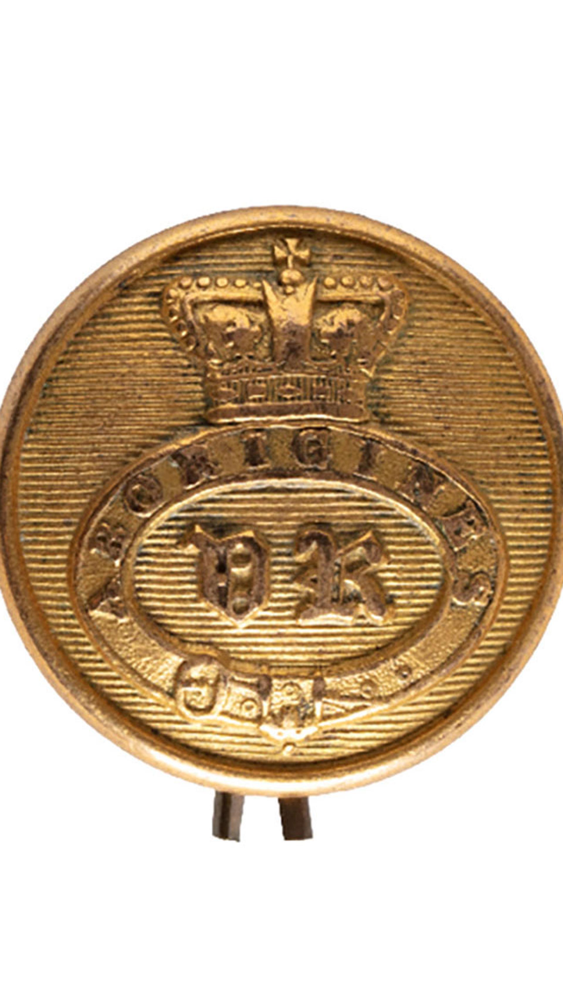 Button with concave back, consisting of a garter band with the inscription "ABORIGINES/ VR" within, surmounted by a crown. The reverse of the button, has a loop for attachment and is inscribed "NEW HOLLAND" Ex Sir John Ferguson & L. Barton collections.