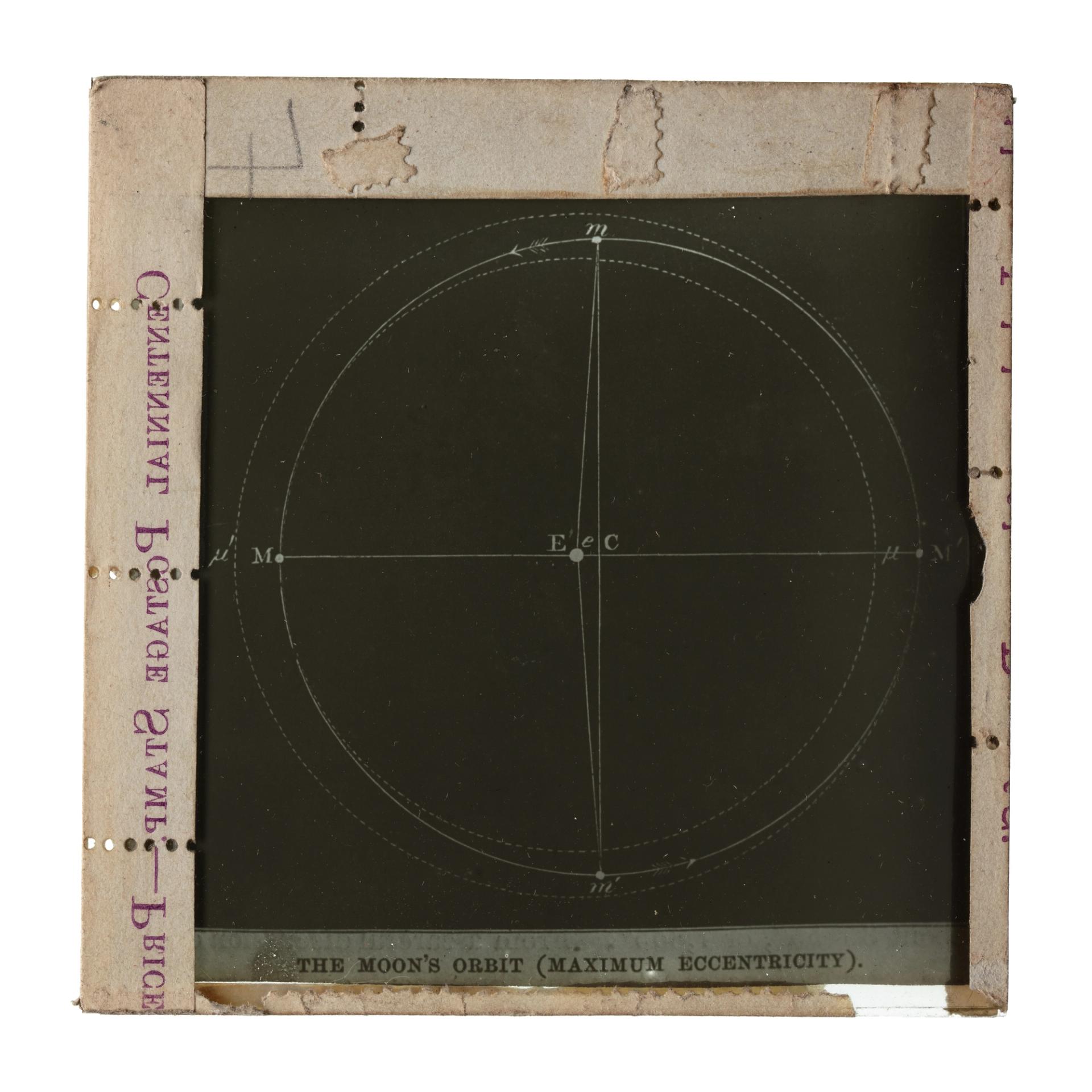Photograph of a framed glass plate slide depicting the Moon's orbit.