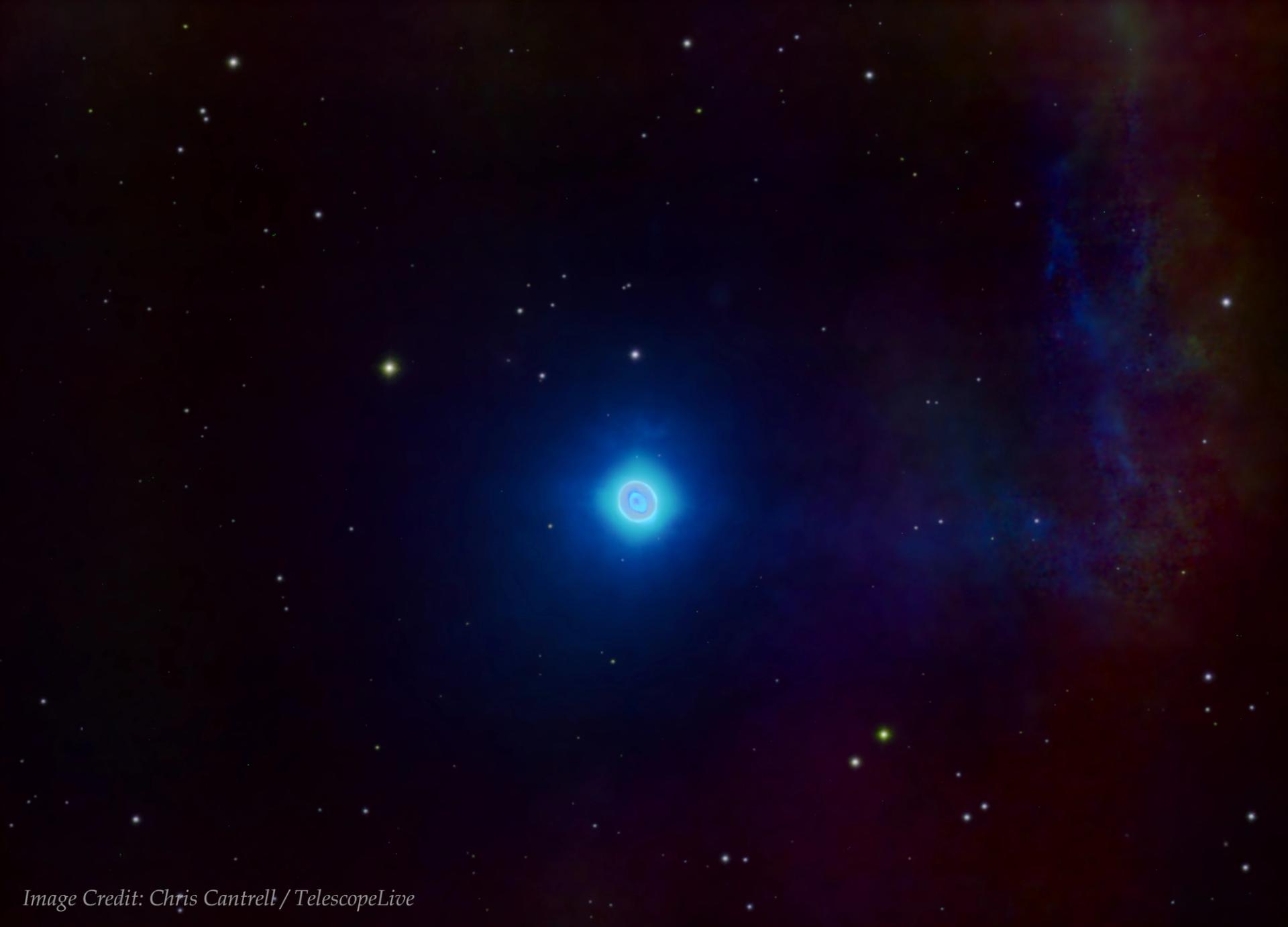 Photograph of a dark space sky with stars scattered, at the centre is a blue glowing orb known as 'The Ghost of Jupiter'.