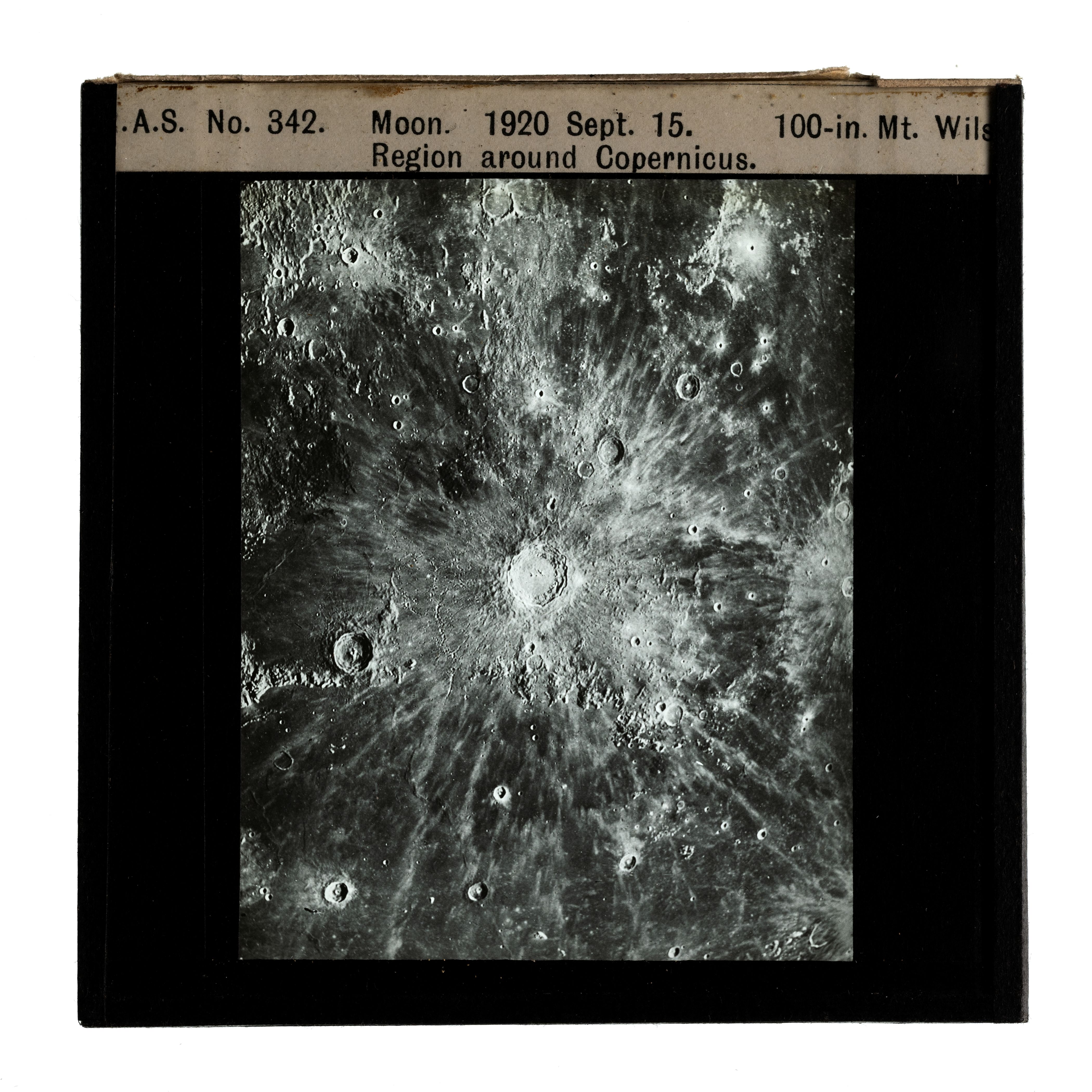 Photograph of a glass plate slide with a black frame and an image showing moon craters in the region around Copernicus Moon. Labelled on the top of the frame with '.A.S. No. 342 Moon. 1920 Sept. 15. 100-in. Mt. Wils — Region around Copernicus.'