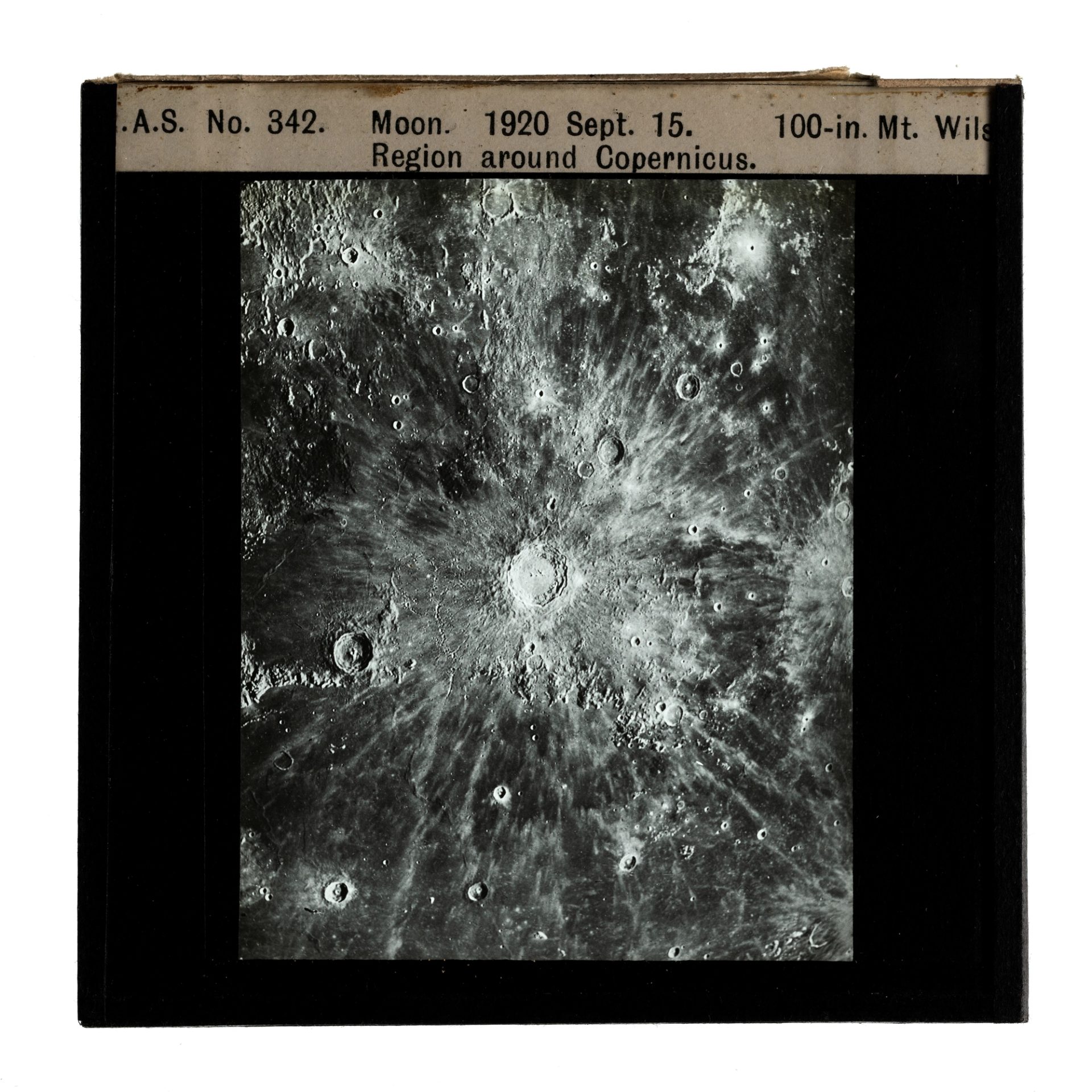 Photograph of a glass plate slide with a black frame and an image showing moon craters in the region around Copernicus Moon. Labelled on the top of the frame with '.A.S. No. 342 Moon. 1920 Sept. 15. 100-in. Mt. Wils — Region around Copernicus.'