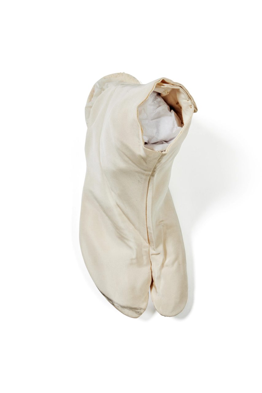 White tabi (right of pair) sock with a split at the toes made of silk, cotton and metal.