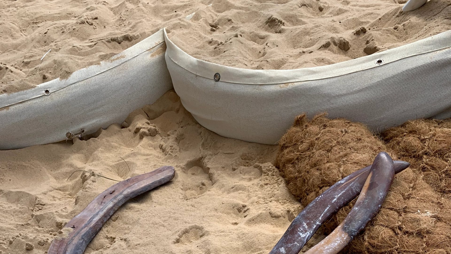 sand with stick and barricades within it