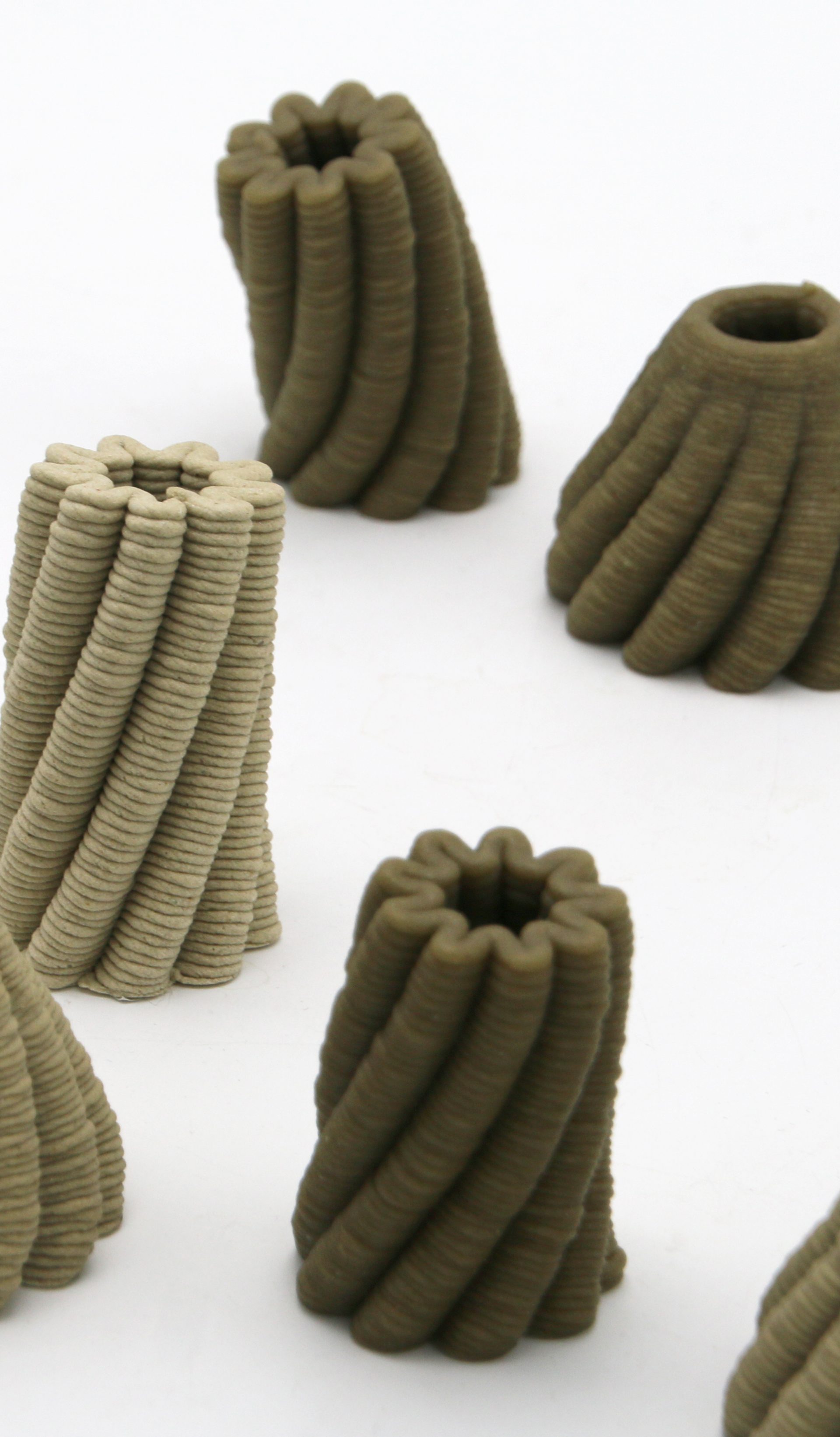 A 3D printer prints a brown, bowl-shaped object with scalloped edges.