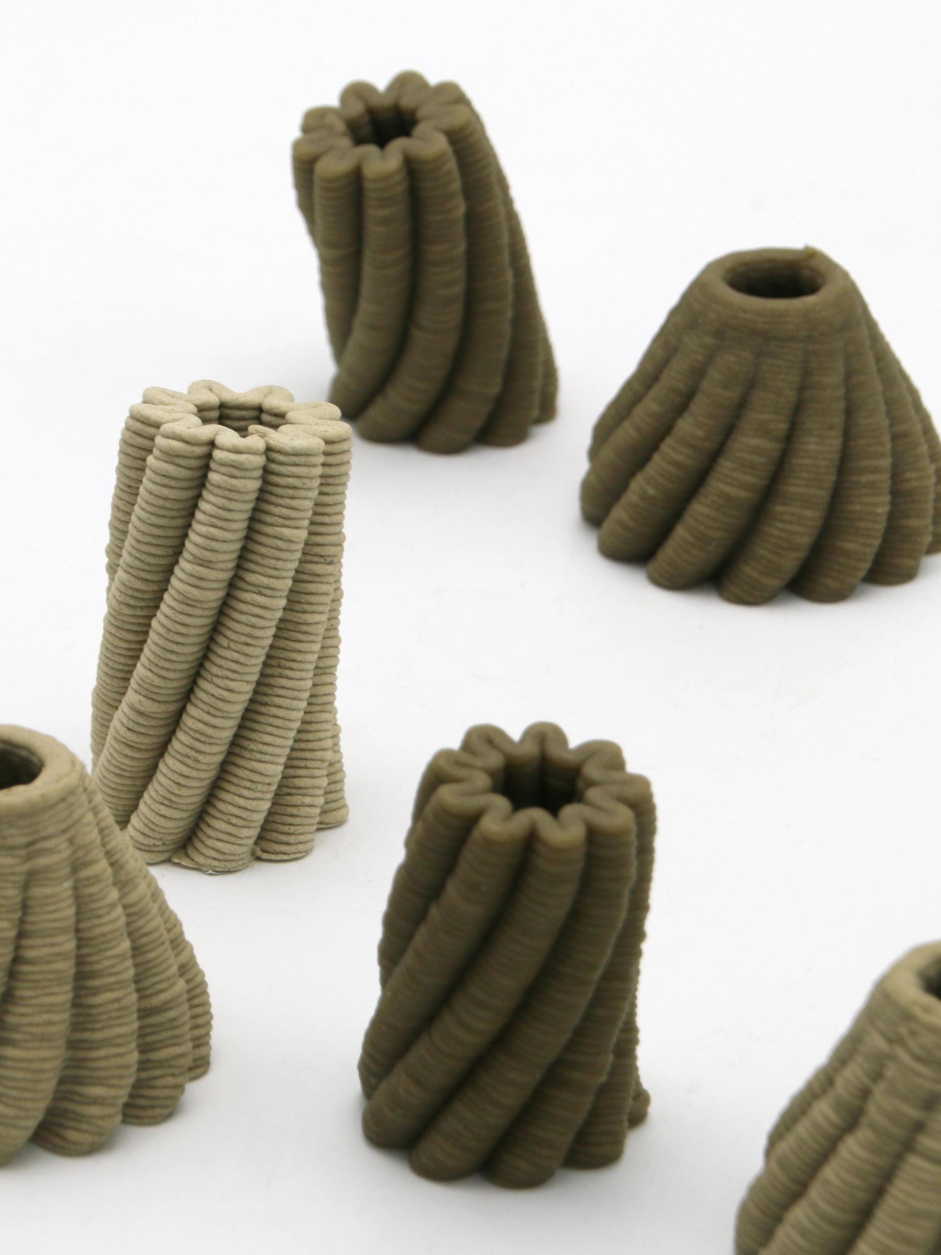 A 3D printer prints a brown, bowl-shaped object with scalloped edges.