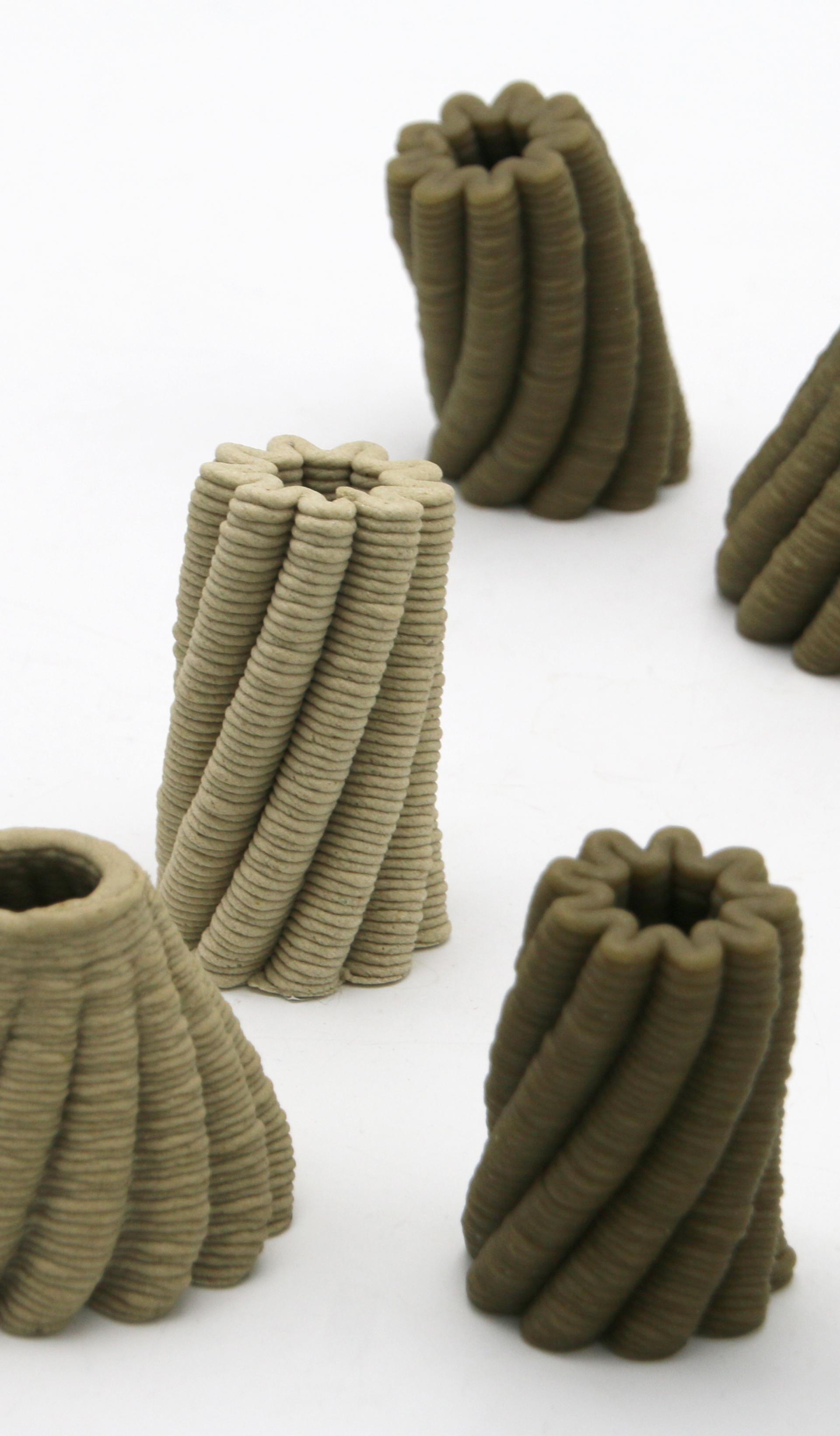 A 3D printer prints a brown, bowl-shaped object with scalloped edges.