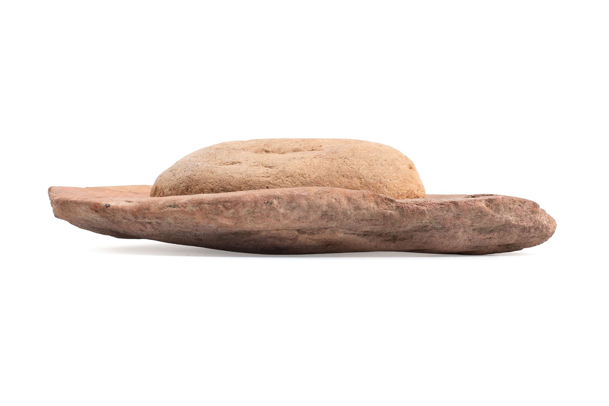 Consisting of a flat oval 'dish' and long rounded grindstone.The dish is of reddish sandstone with its upper surface hollowed/ground out.The grindstone is a long oval loaf shape, with flat, smoothly polished underside.