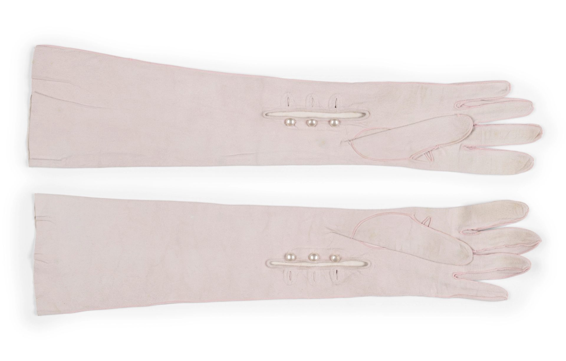 Light pink gloves, mid-forearm length, made of kid leather.
