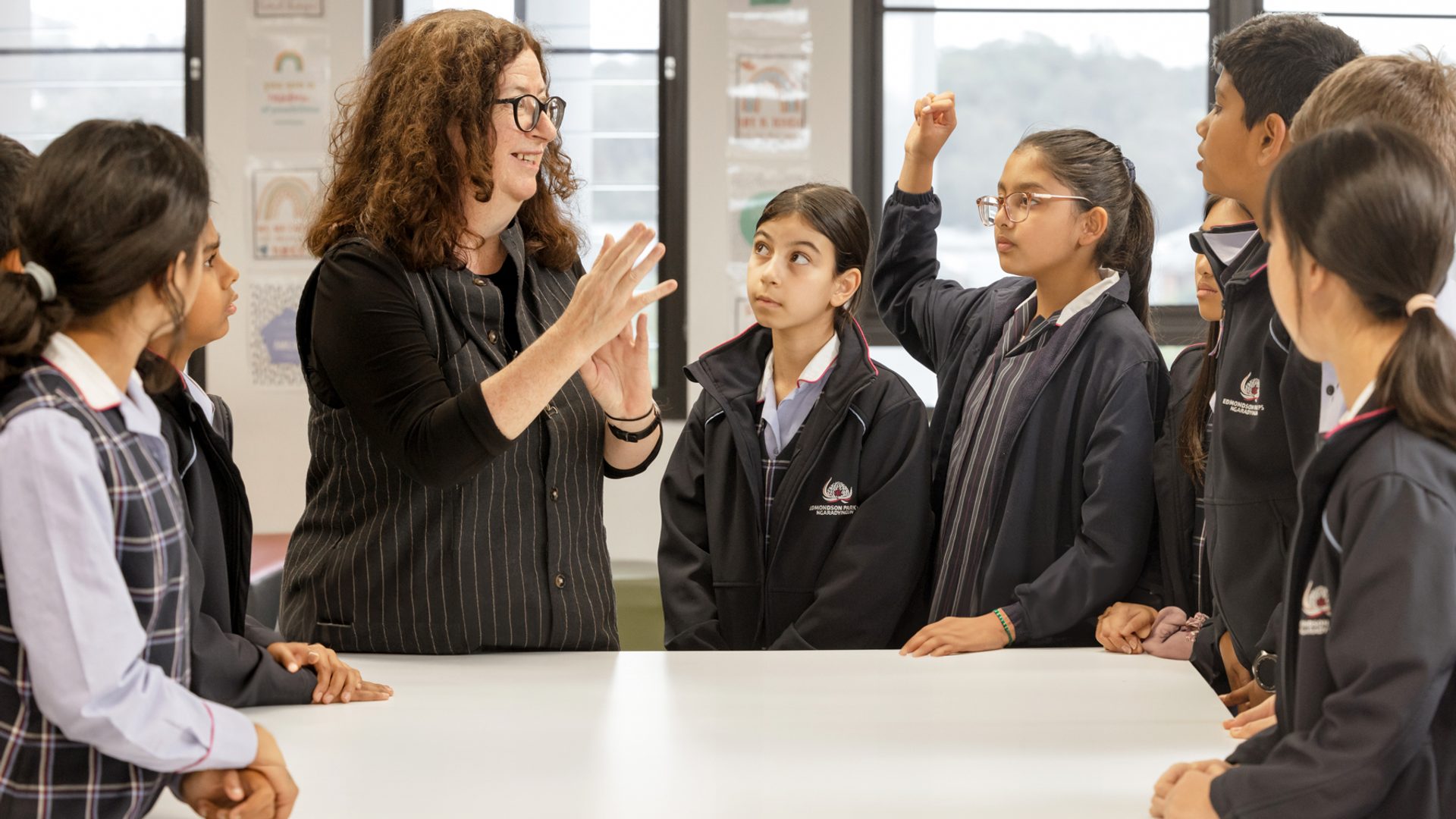 Woman with young female students.