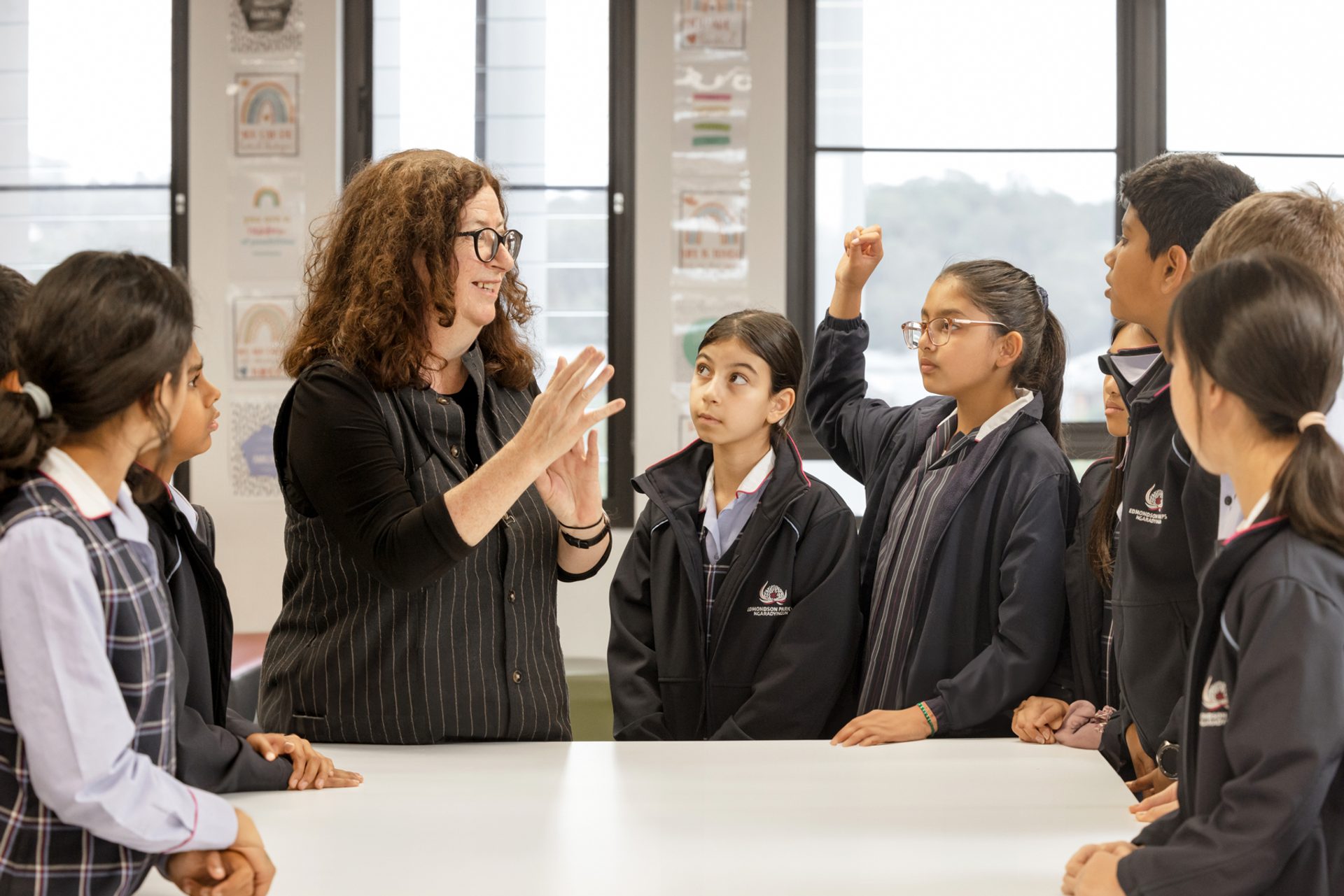Woman with young female students.