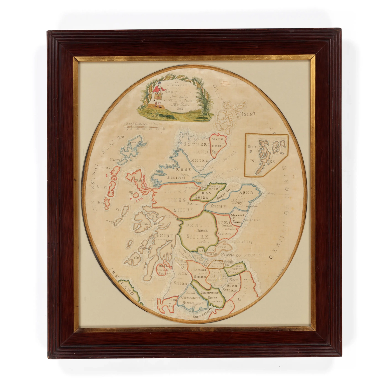 A brown and gold framed map of Scotland using embroidery.