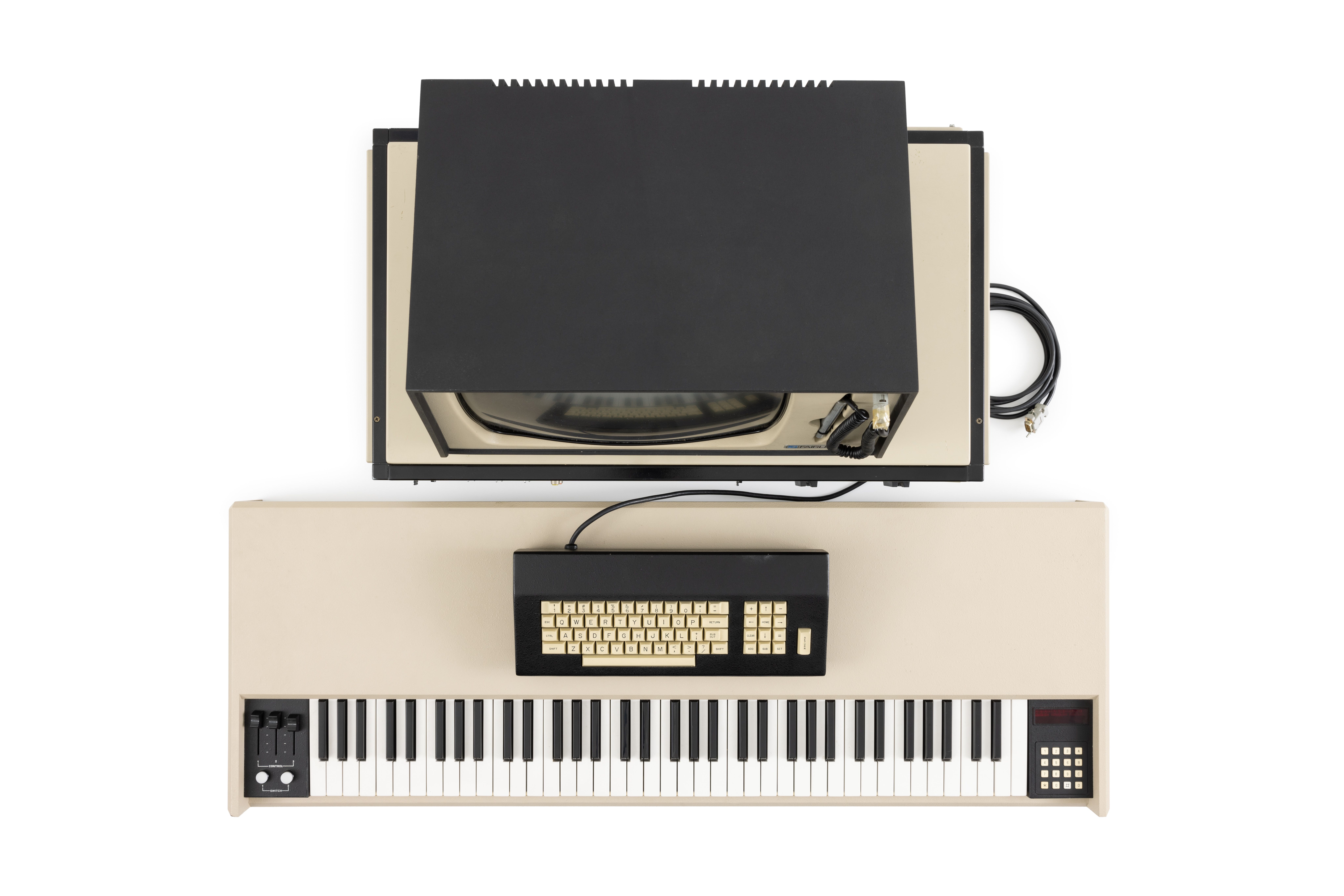 The Fairlight CMI (Computer Musical Instrument) consists of a central processing unit, a video monitor with attached light-pen, a computer keyboard and a music keyboard. Accessories for the instrument include the floppy disks used to store data, power cords and manuals.