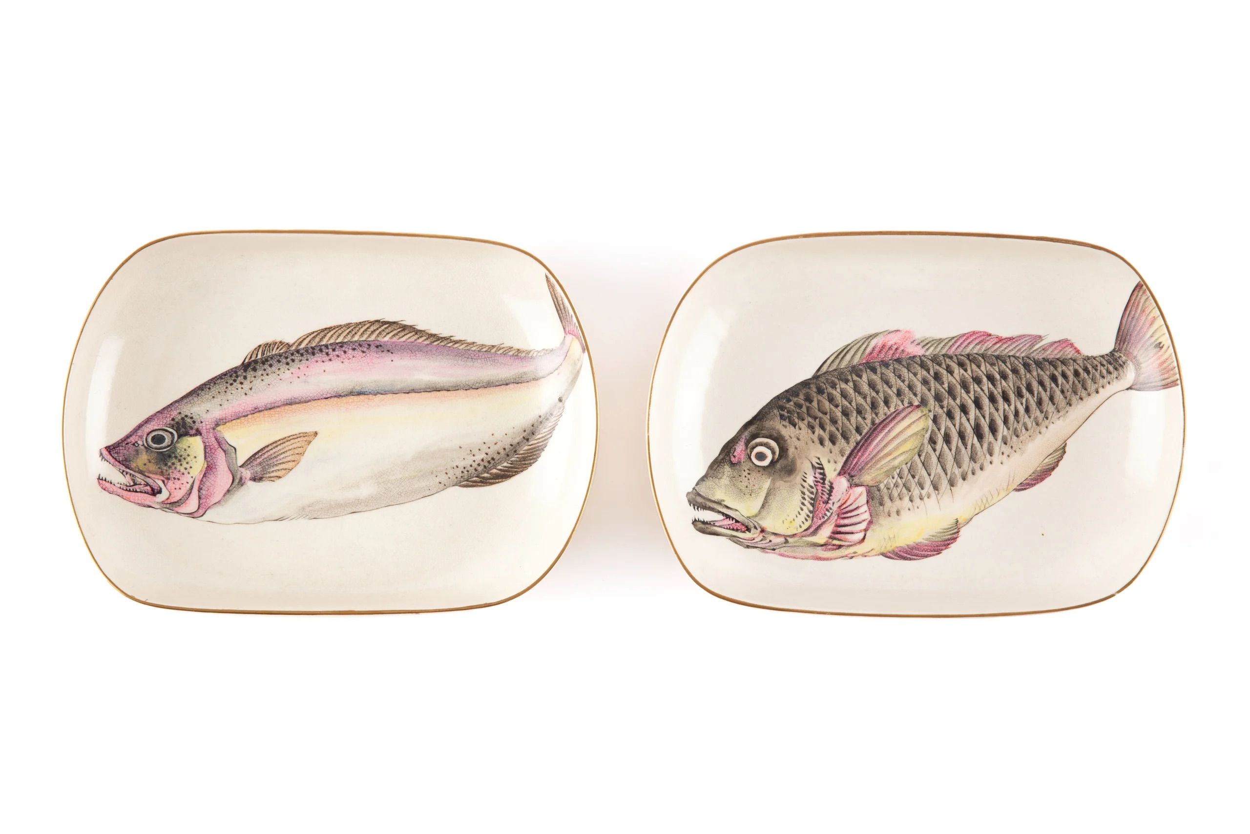 Three Japanese porcelain dishes, each featuring a painting of a fish.