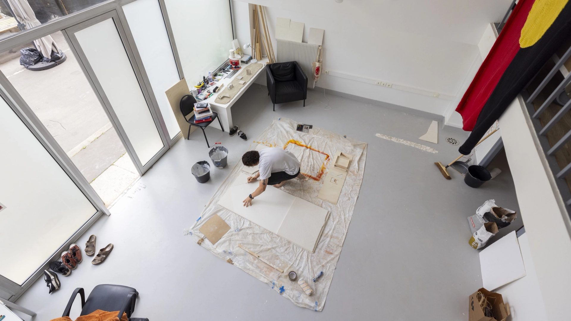 Birds-eye view of figure working on the floor.