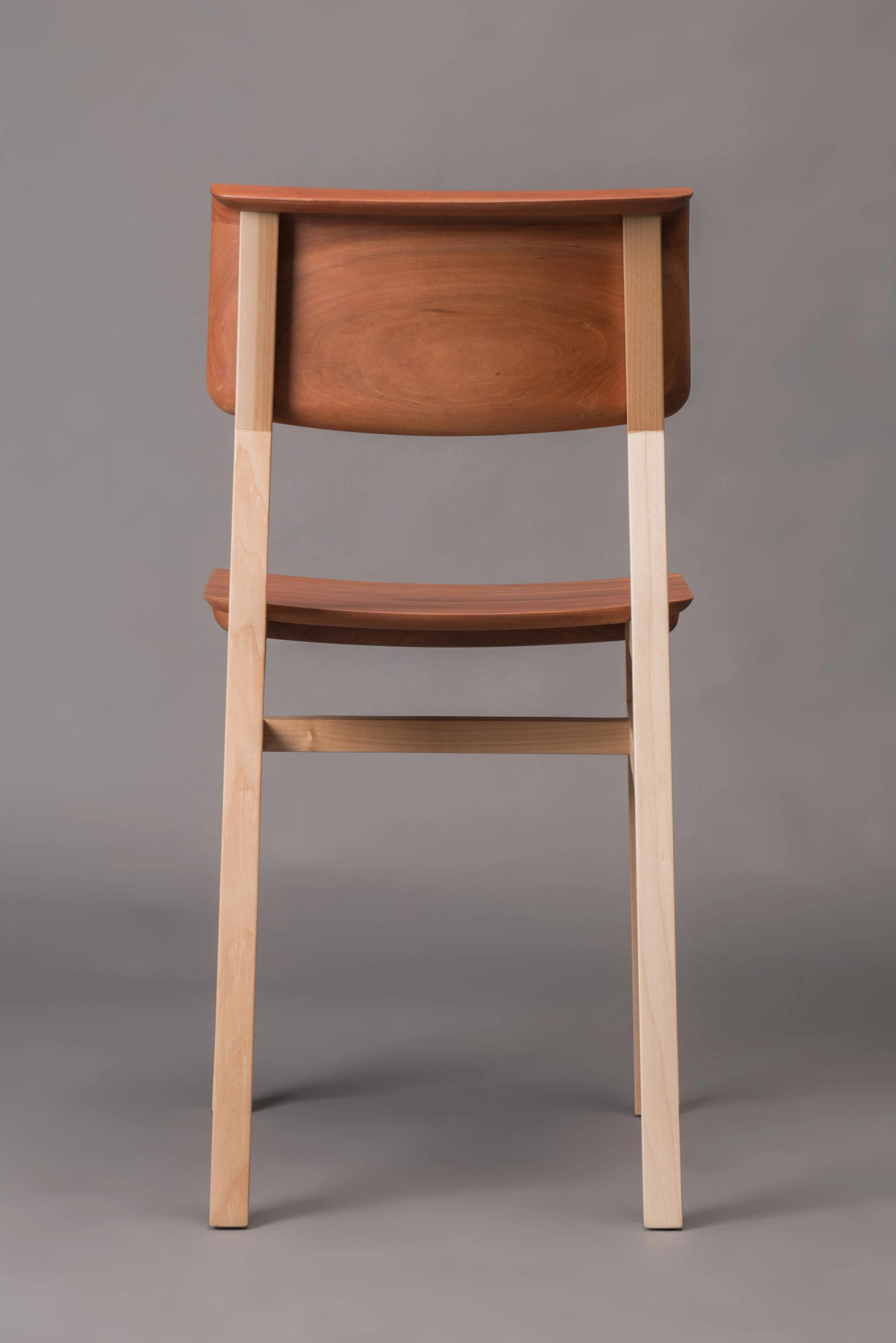Wooden chair from behind, in photo studio.