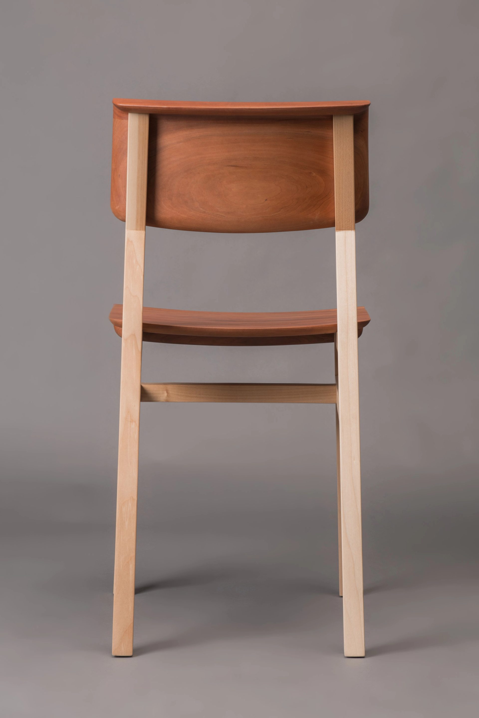 Wooden chair from behind, in photo studio.