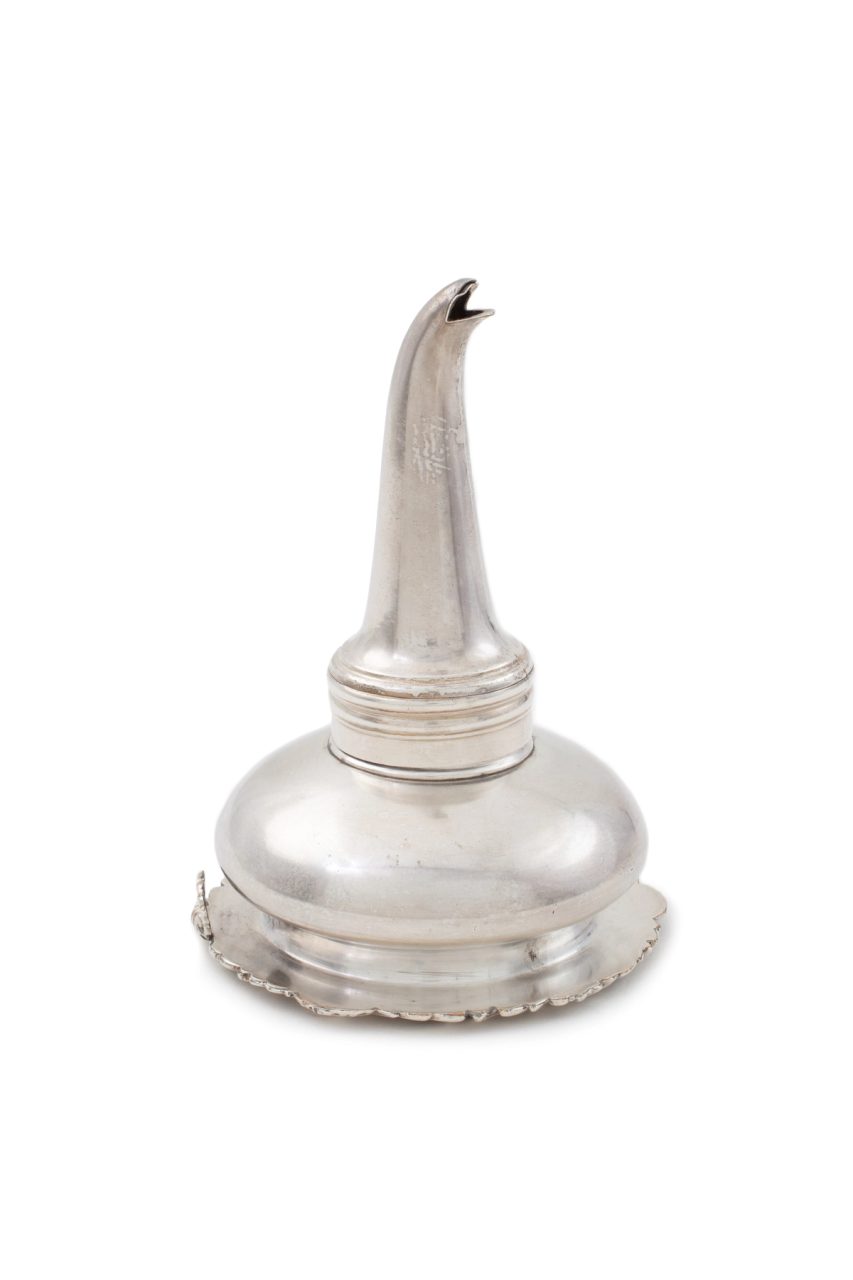 A silver wine strainer in the shape of an upside down funnel.