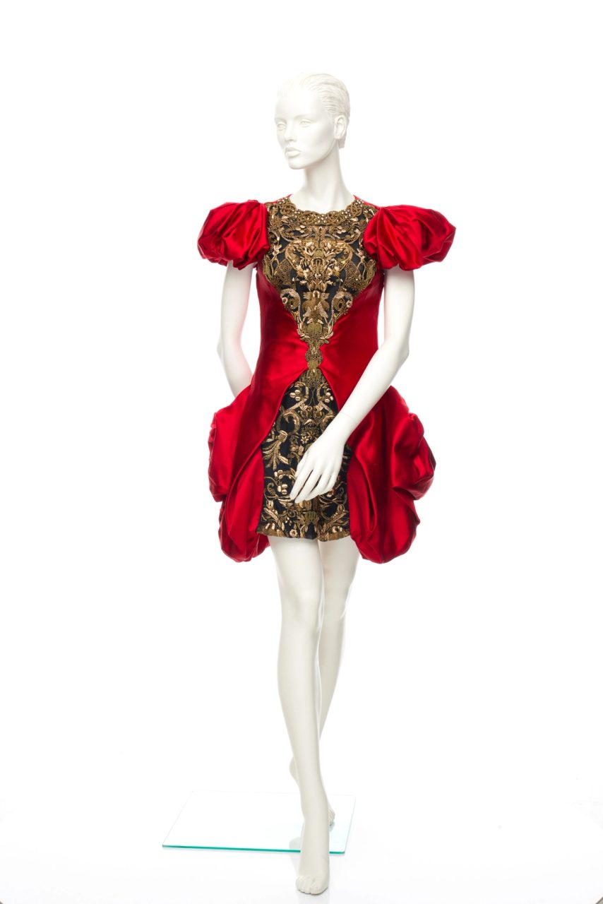 Red pillowy dress with golden features in the middle.