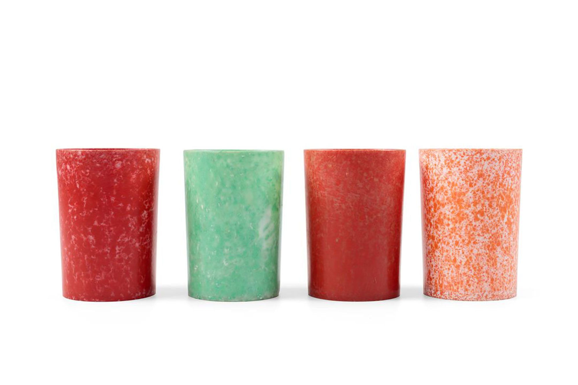 Four small beakers, created to contain Vegemite, each in a different colour including pale green / white, orange / white, red / pink / white and red / brown / white.