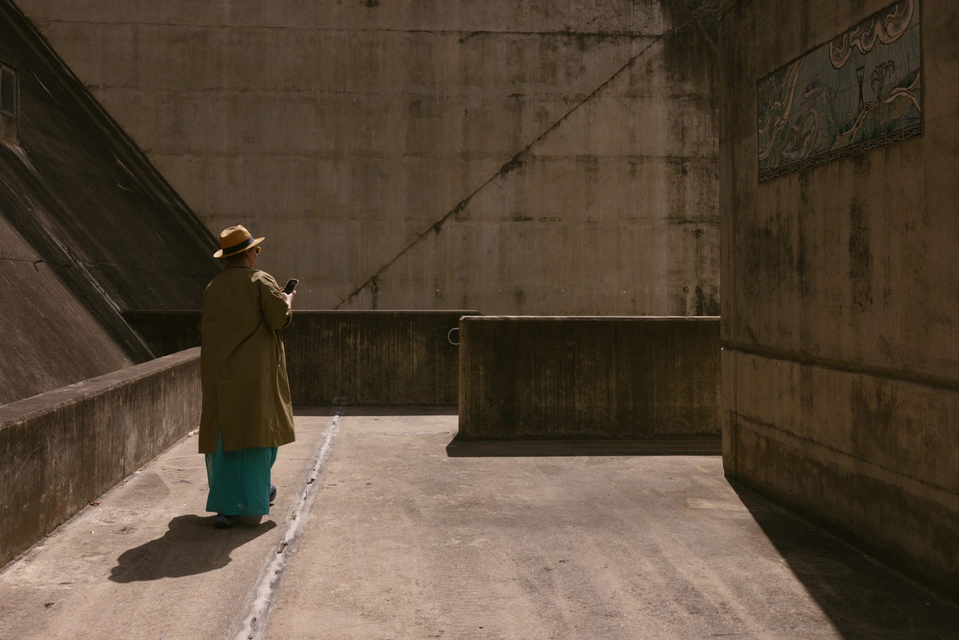 Figure walking around concrete structures of the dam