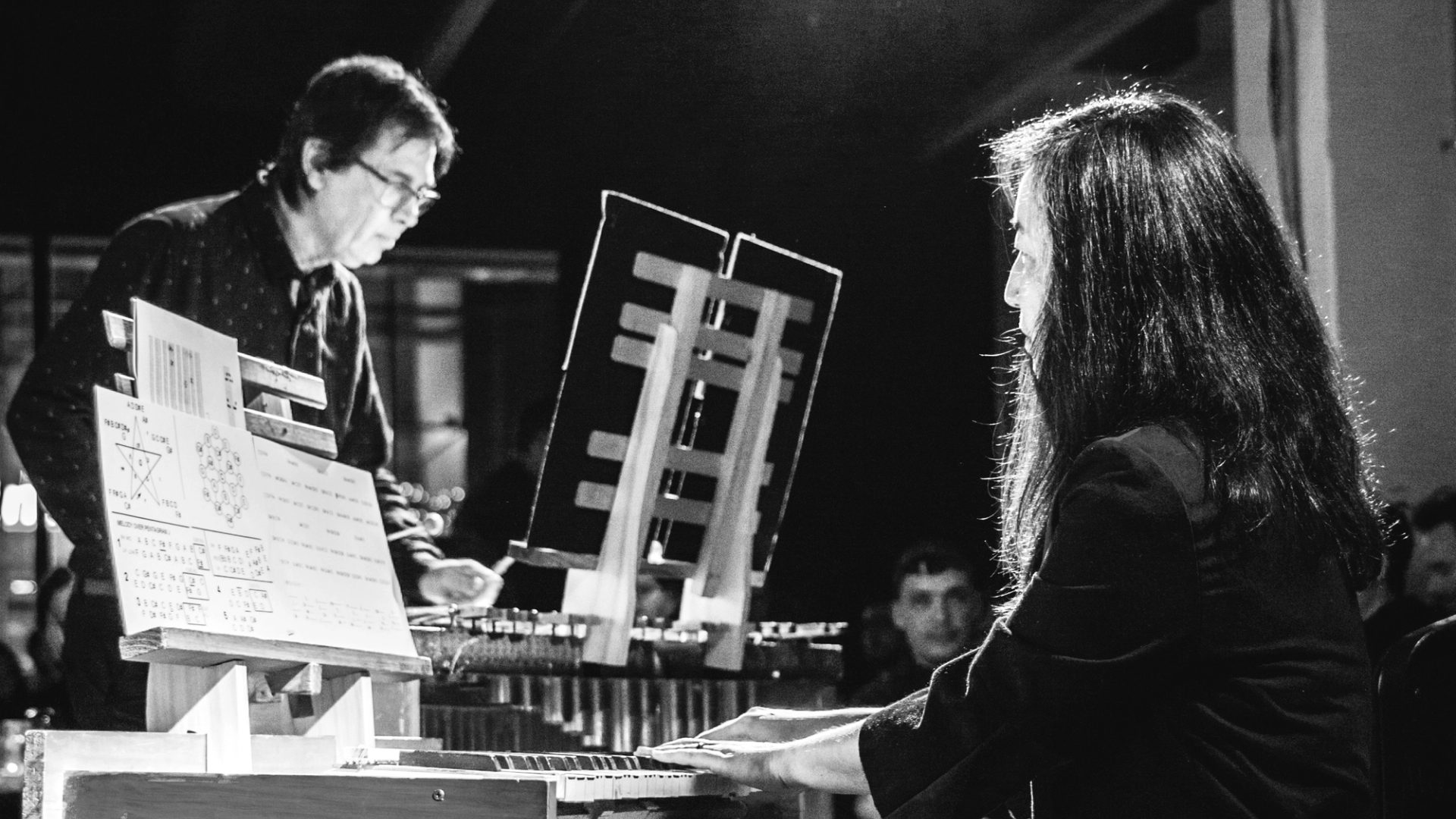 Black and white photo of two people playing music