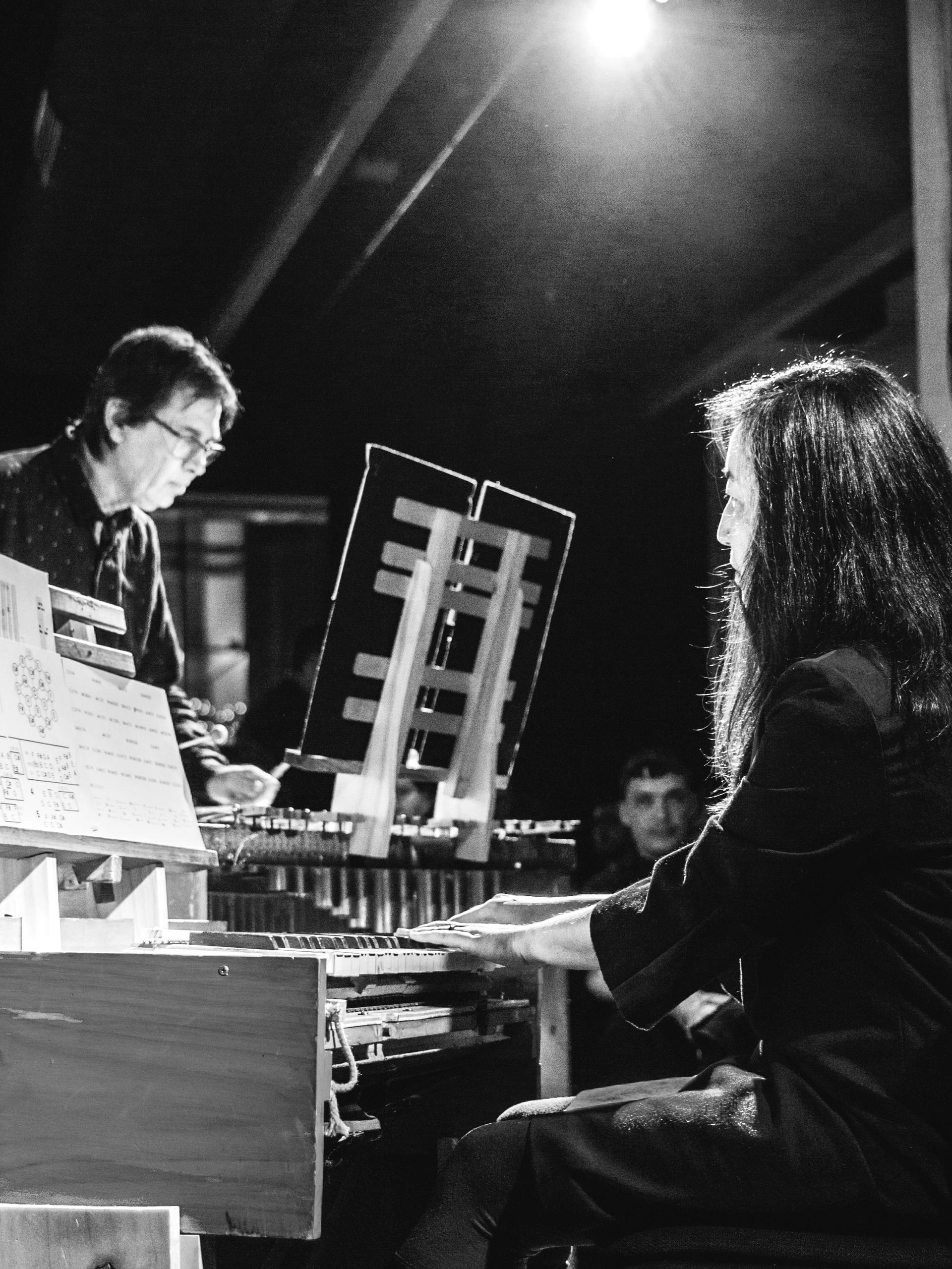 Black and white photo of two people playing music