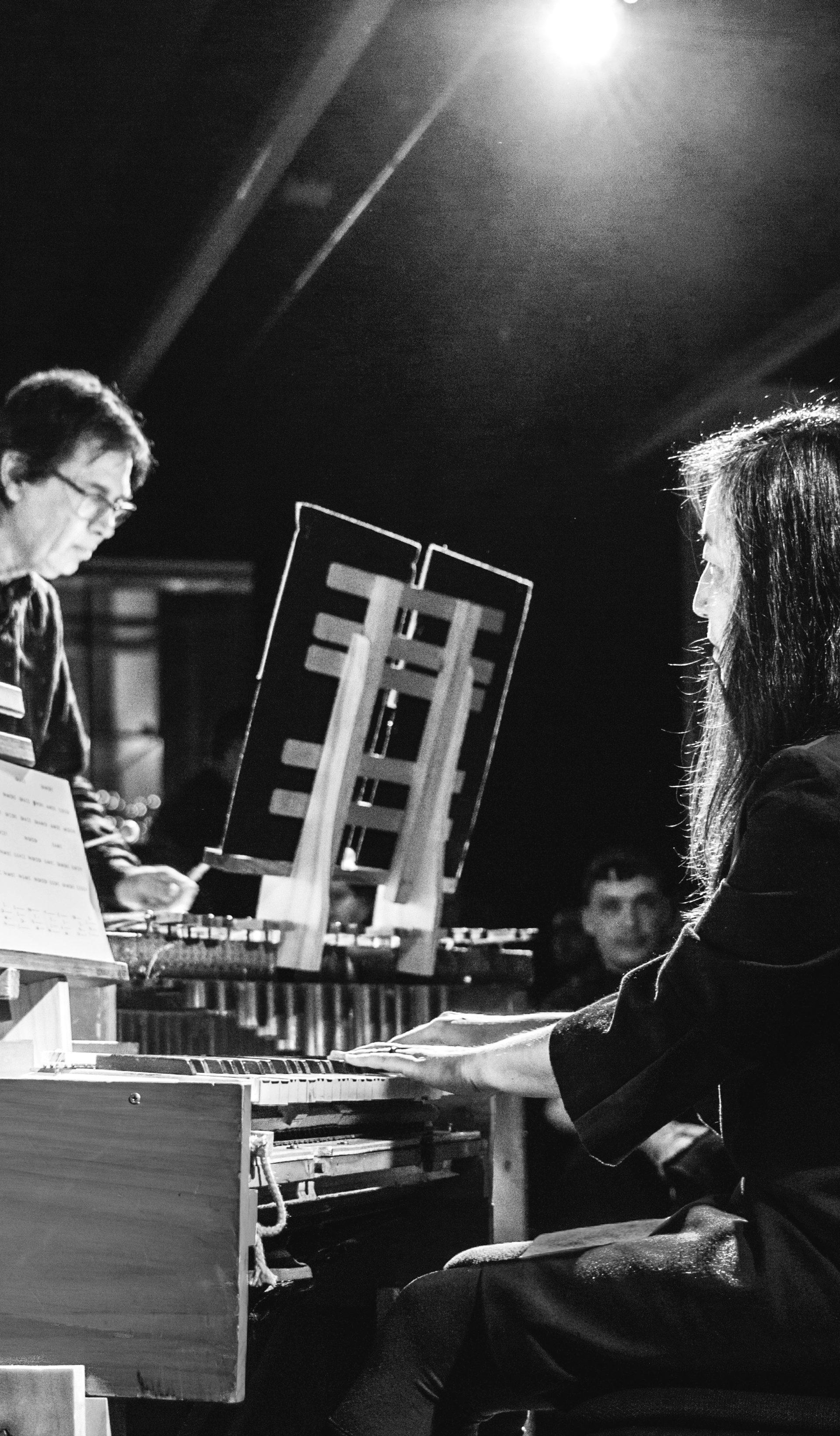 Black and white photo of two people playing music