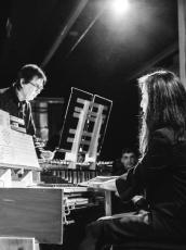Black and white photo of two people playing music