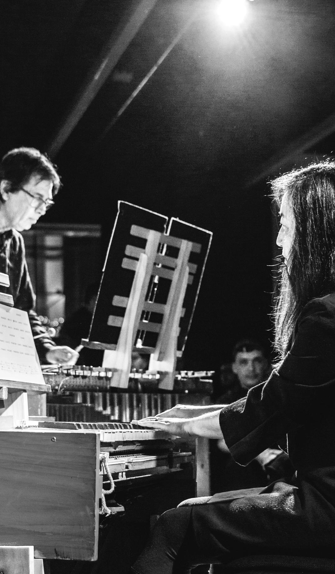 Black and white photo of two people playing music
