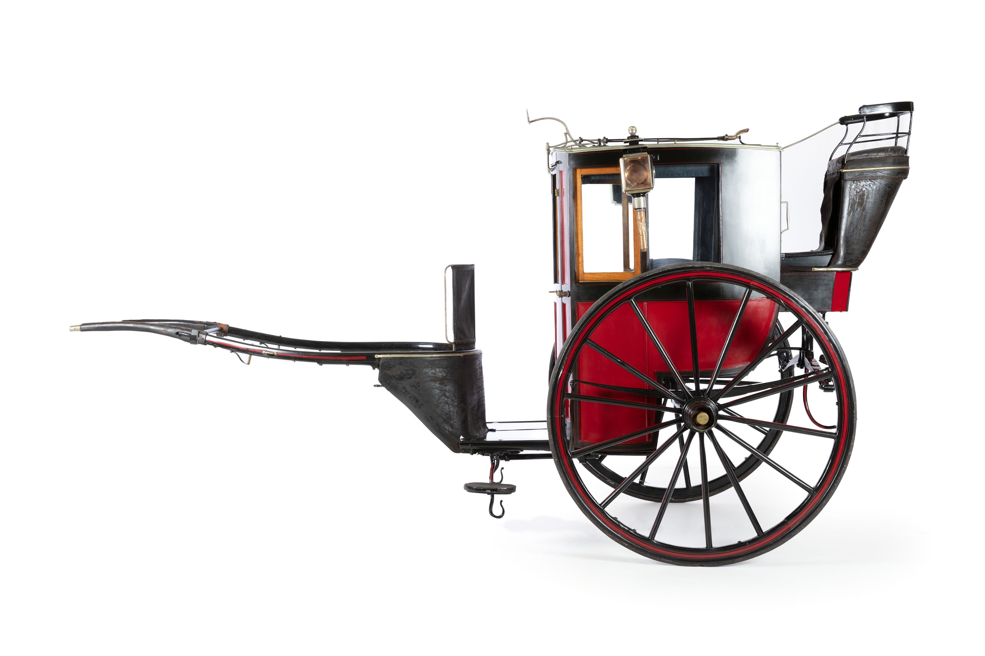 A two-wheeled enclosed horse-drawn vehicle. On either side of the cab are brass carriage lamps, large timber-spoked wheels and a driver's seat high at the rear of the cab.