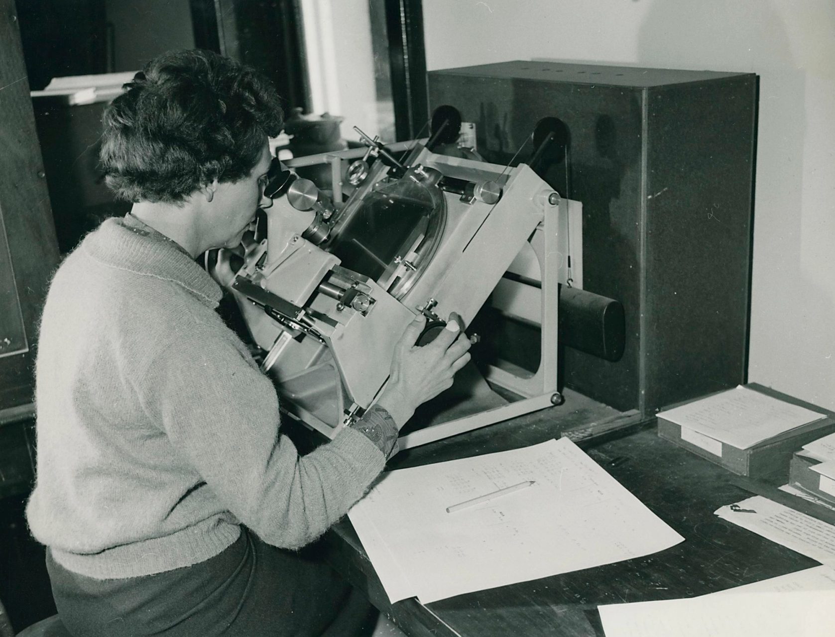 Researcher pressing their head onto a plate measuring machine
