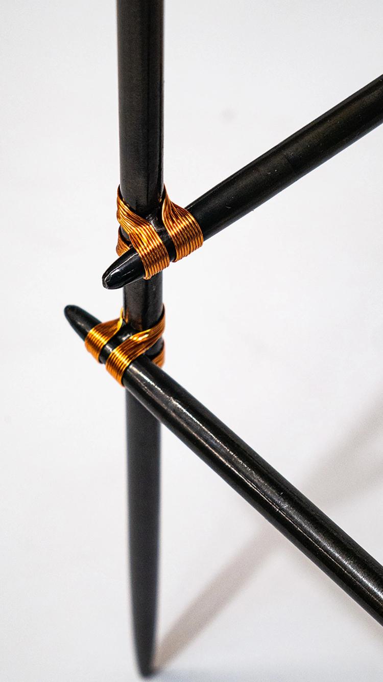 A close up image of the table legs and the coiled metallic joining.
