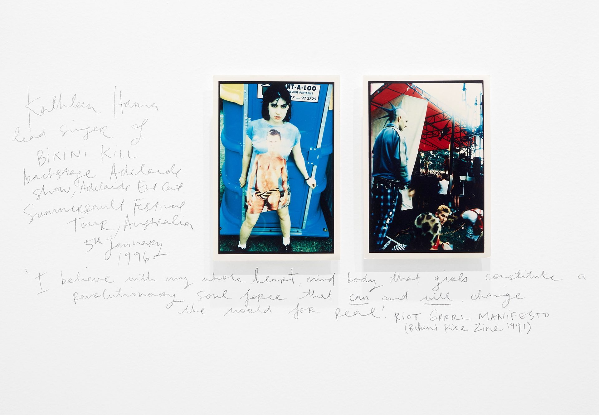 A white wall with two framed pictures on it.