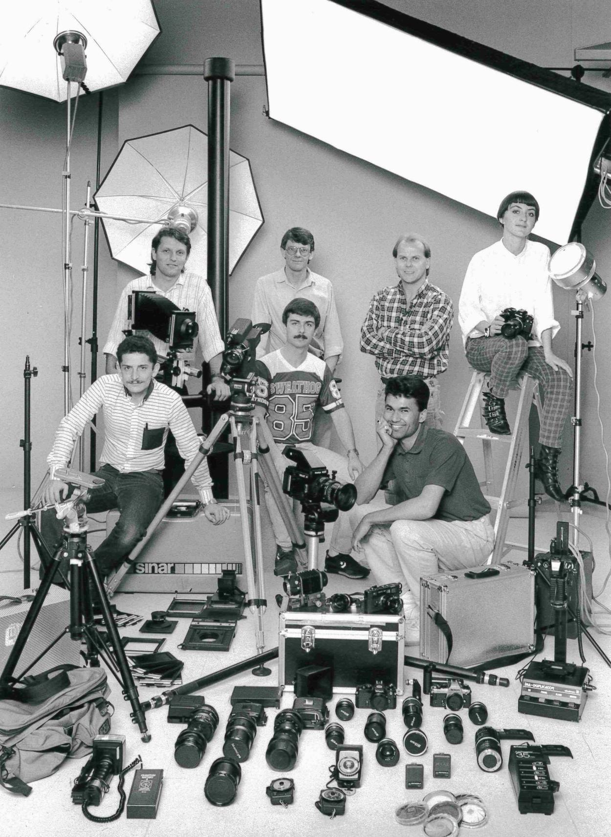 Black and white image of a photography team in a studio