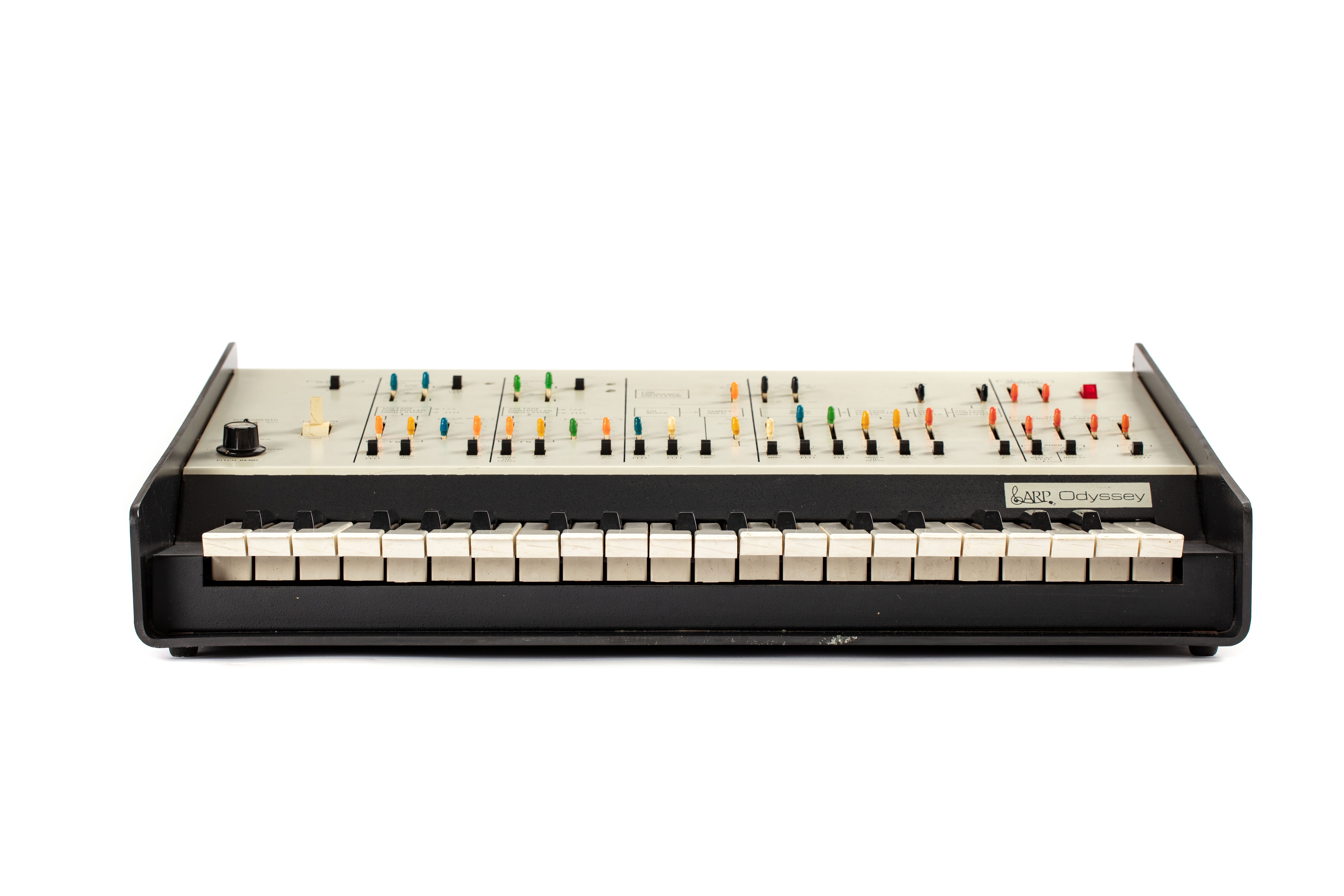 A duophonic synthesizer consisting of a three octave compass keyboard and control panel. The control panel is divided into six parallel sections. The sections include switches and controls to operate various functions. The body of the synthesizer is a single piece of moulded black plastic which bends up at sides to form sloping wings each side. At the rear of the instrument is a series of sockets, jacks and a mains lead.