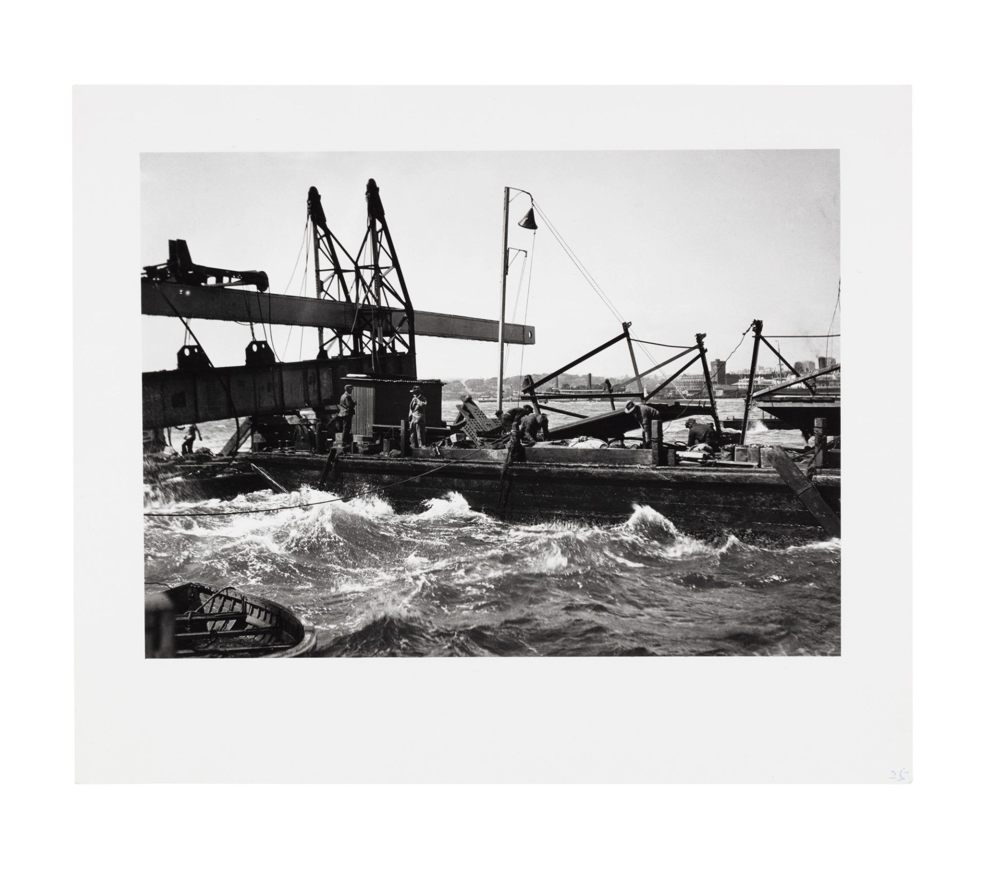 The image has a white border and shows a number of figures working on a pier, or possibly a barge, preparing pieces of the harbour bridge to be craned into position. There is a boat in the lower left corner.