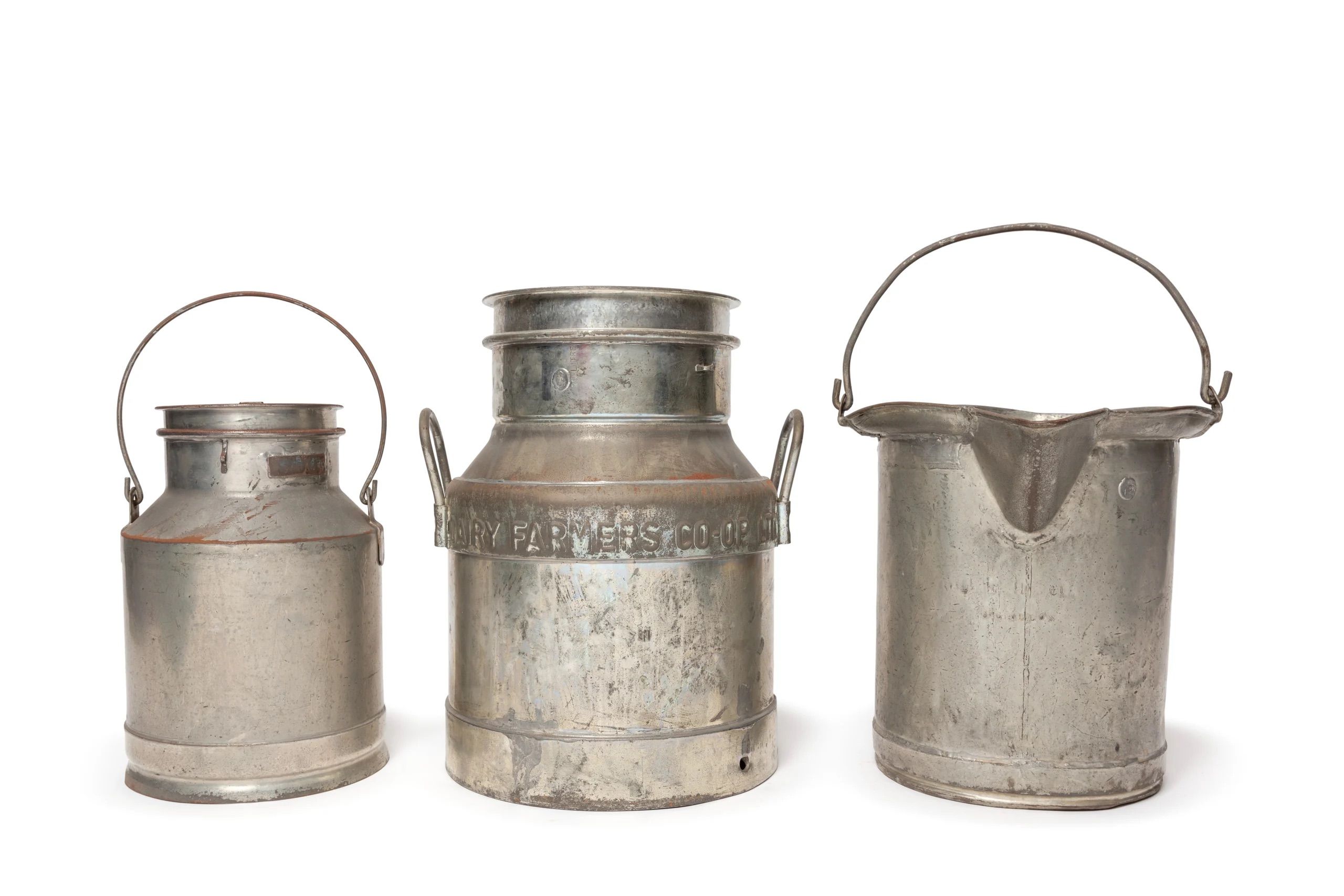 Four milk measures made of tin.