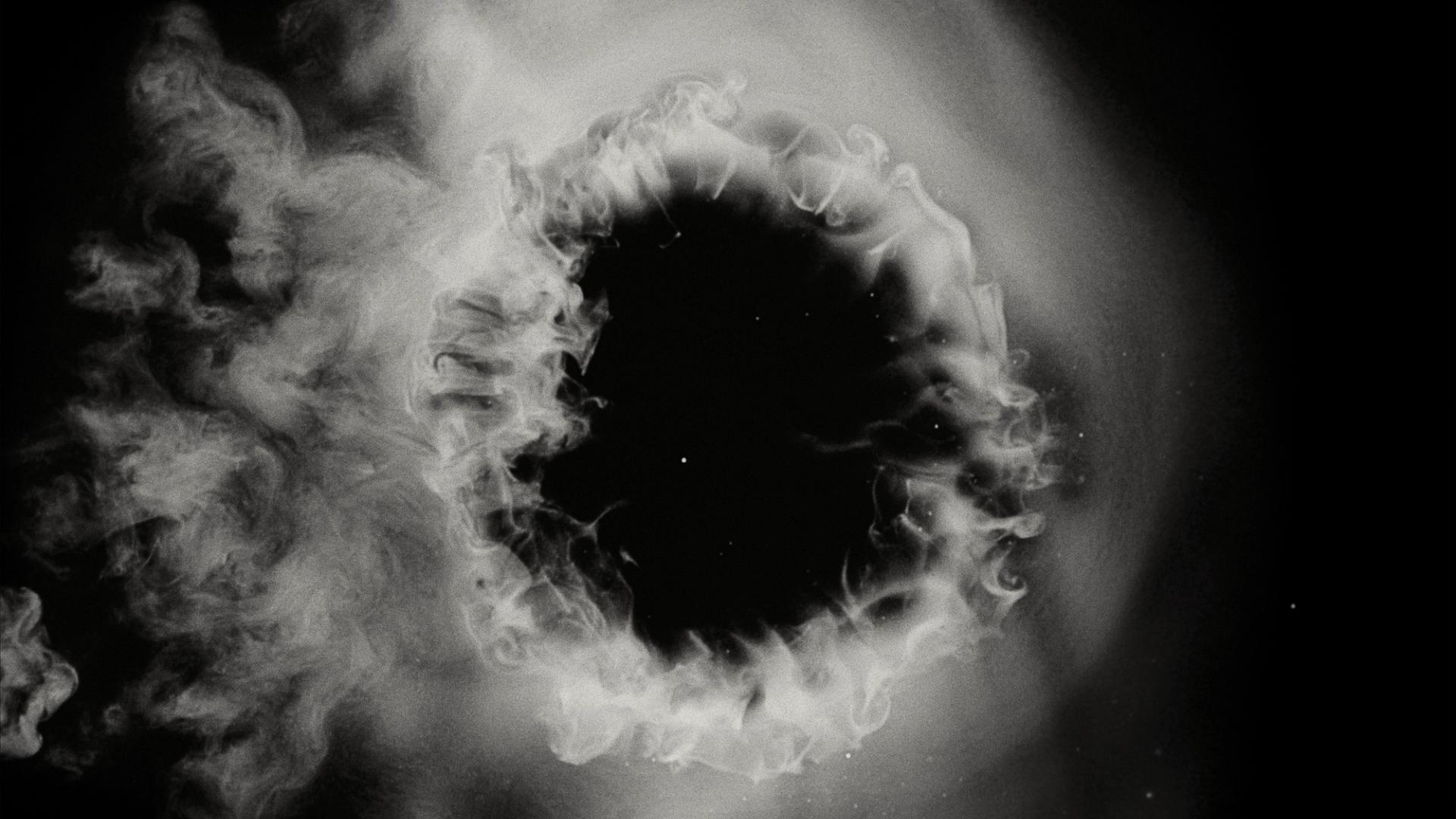 White smoke cloud with a black, starry background.