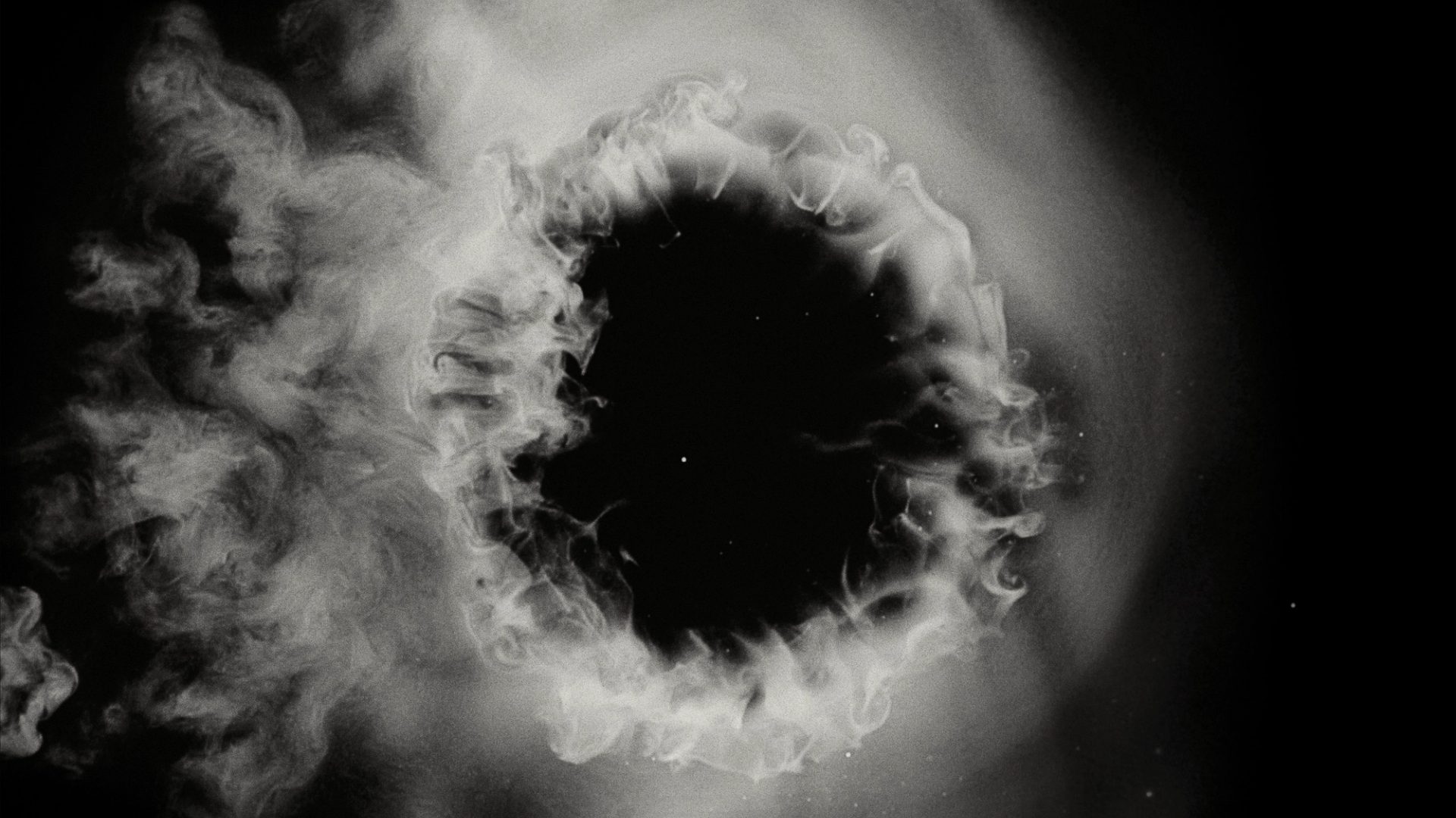 White smoke cloud with a black, starry background.