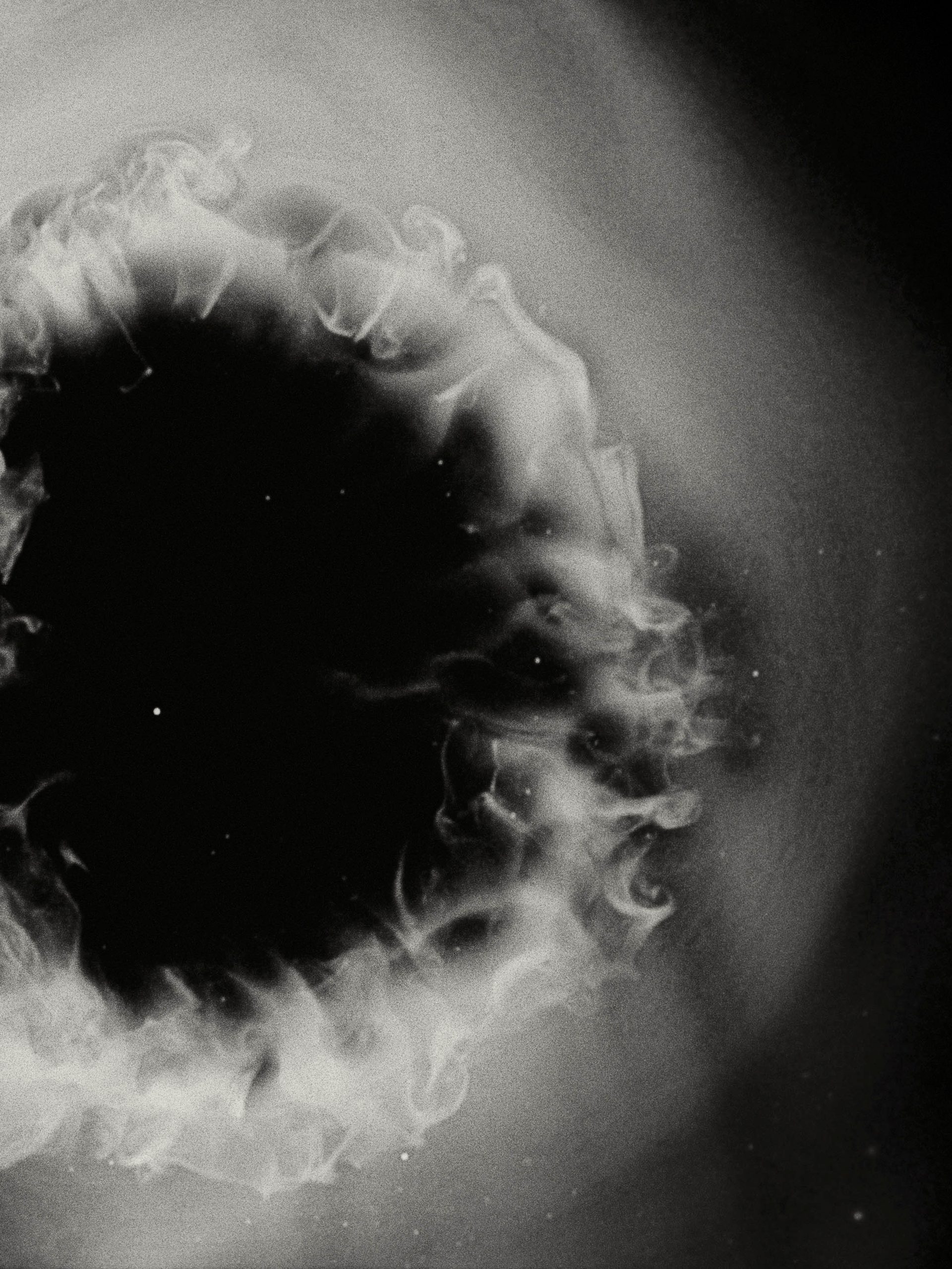 White smoke cloud with a black, starry background.
