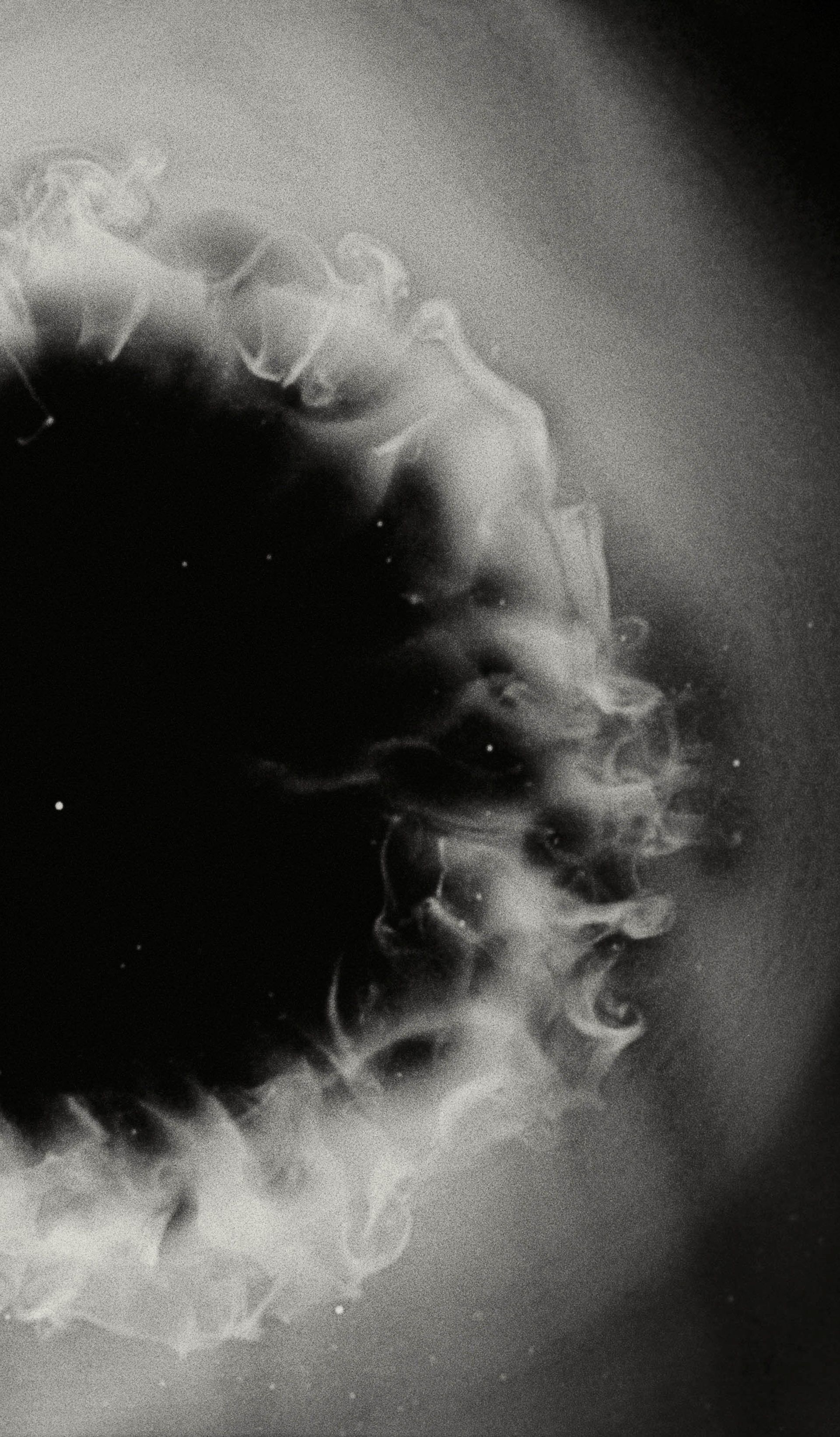White smoke cloud with a black, starry background.