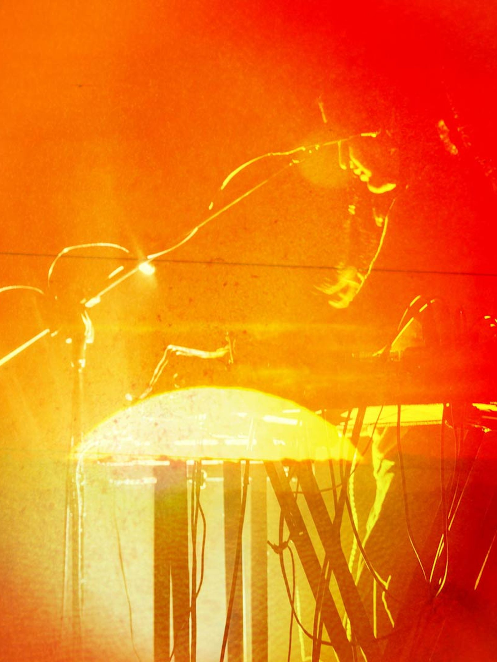 Photo bashed motion image with bright orange sunsets and natural textures over a silhouette of musician Aarti Jadu.