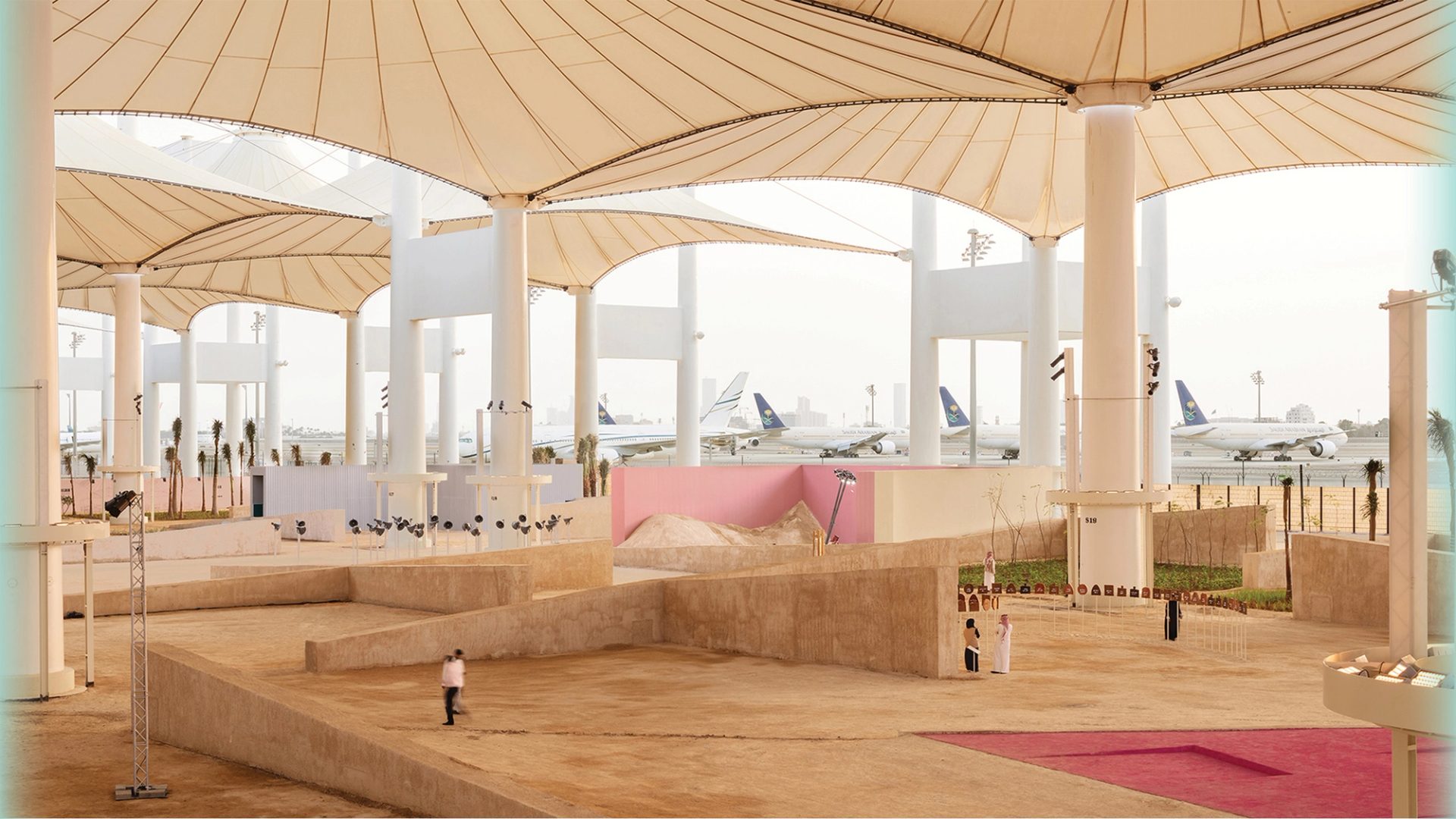 Large installation space outside, under giant umbrellas.