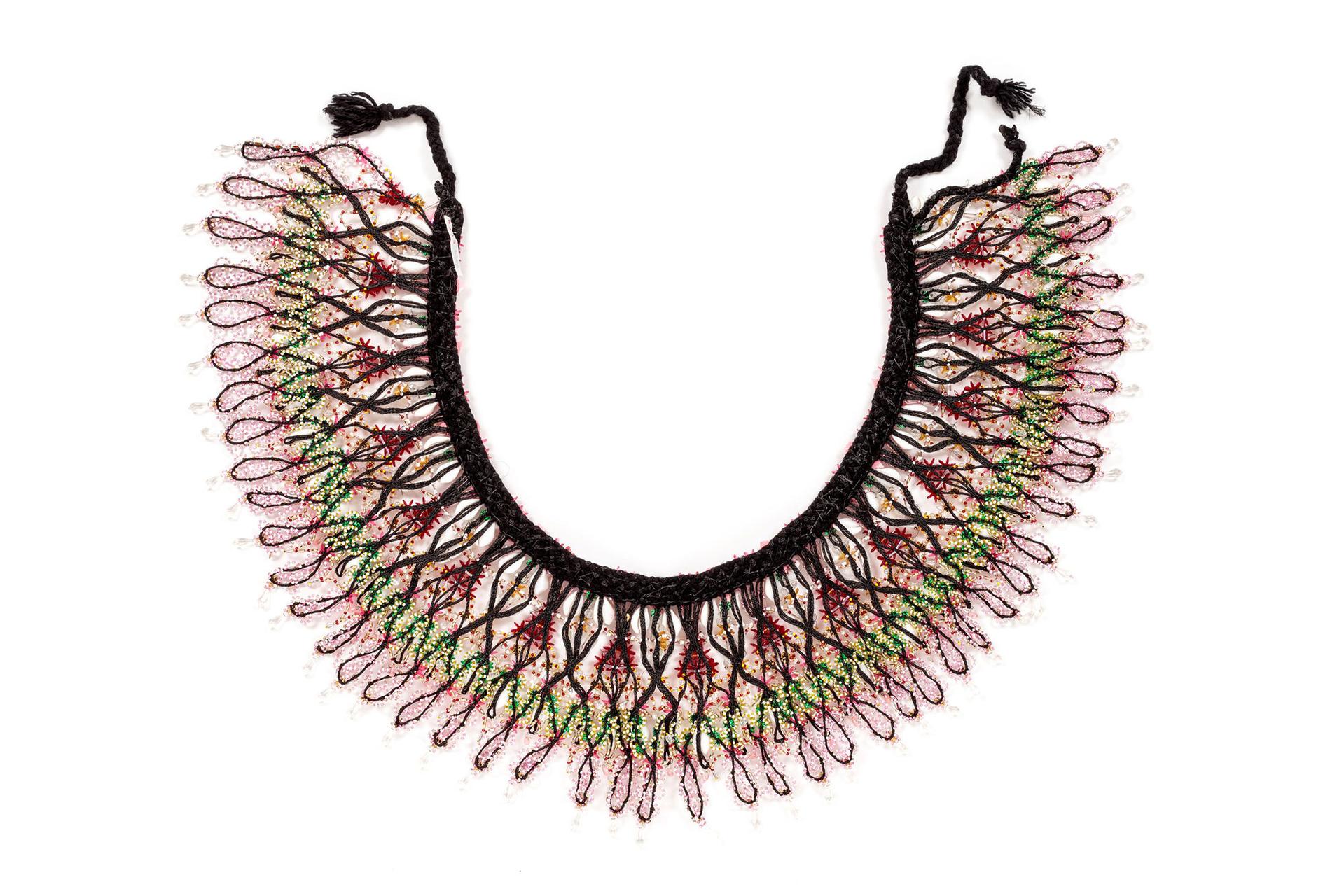 Black synthetic, plaited-braid, waistband with six bands of layered, threaded ornament consisting of a variety of coloured ornaments.