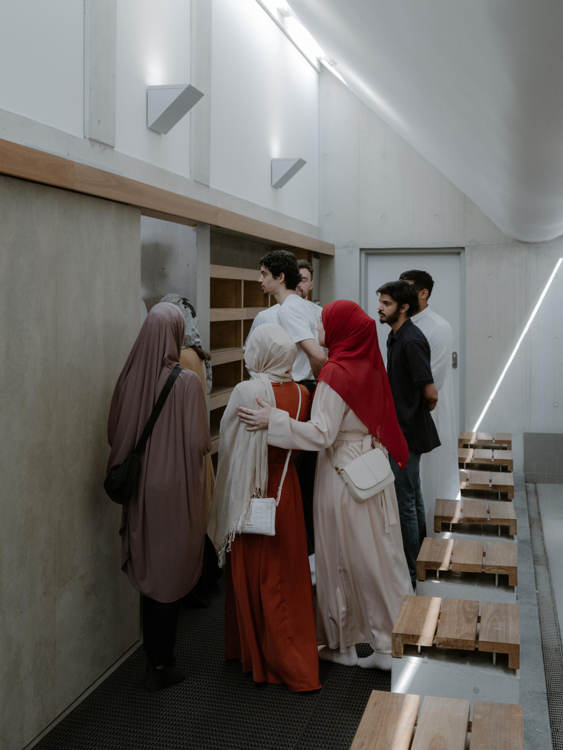 Figures waiting to walk through a doorway while standing