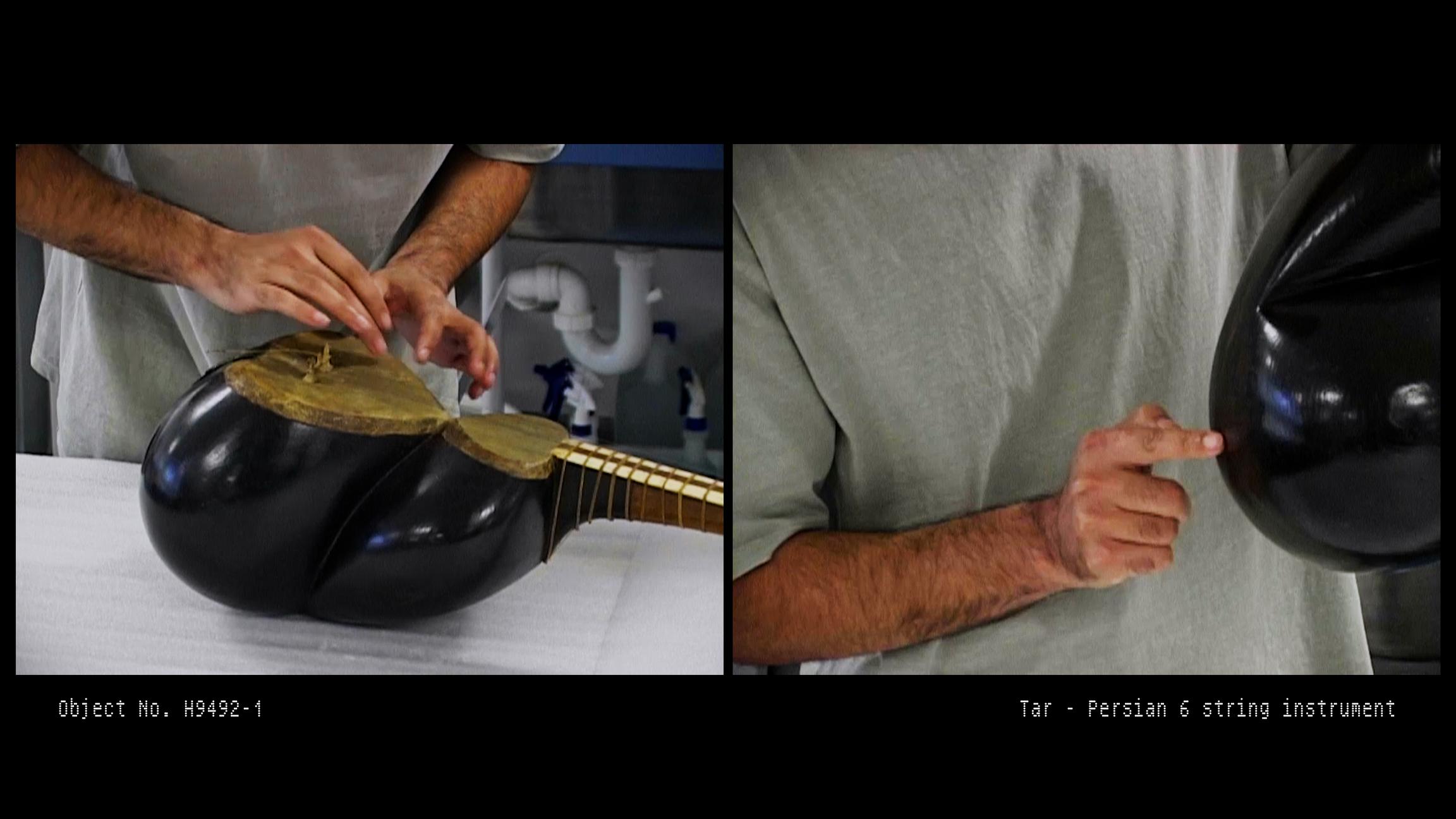 Hamed Sadeghi inspects the Persian tar musical instrument
